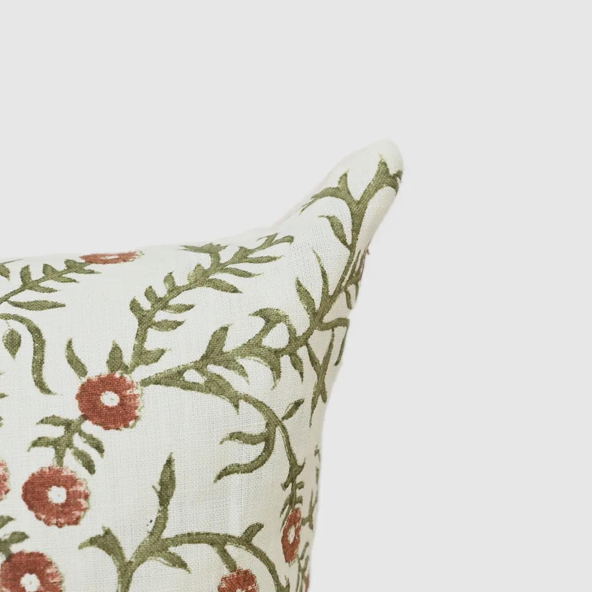 Close-up of terracotta floral bud print with sage vines on linen