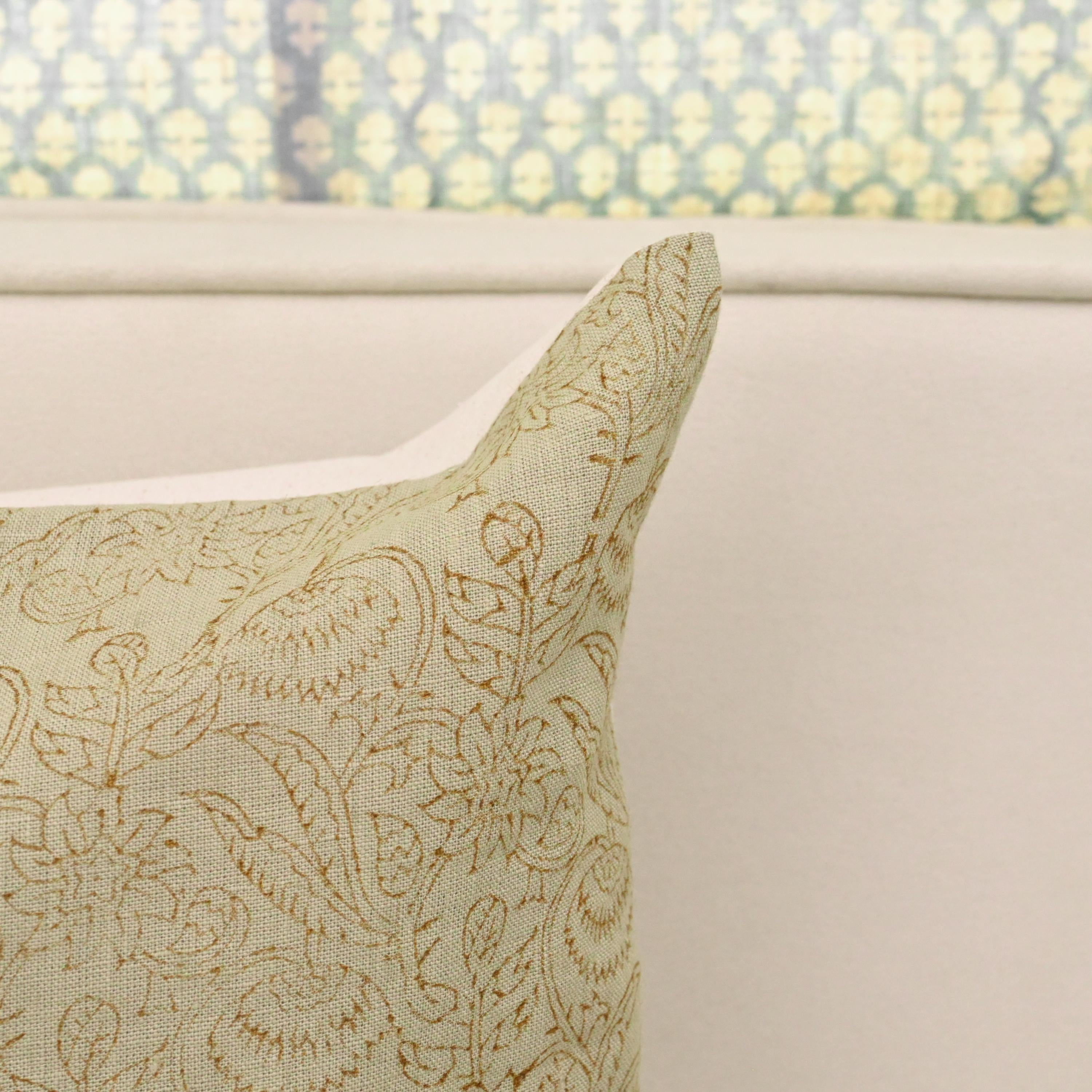 Close-up of hand block printed chintz vine pattern on sage green linen
