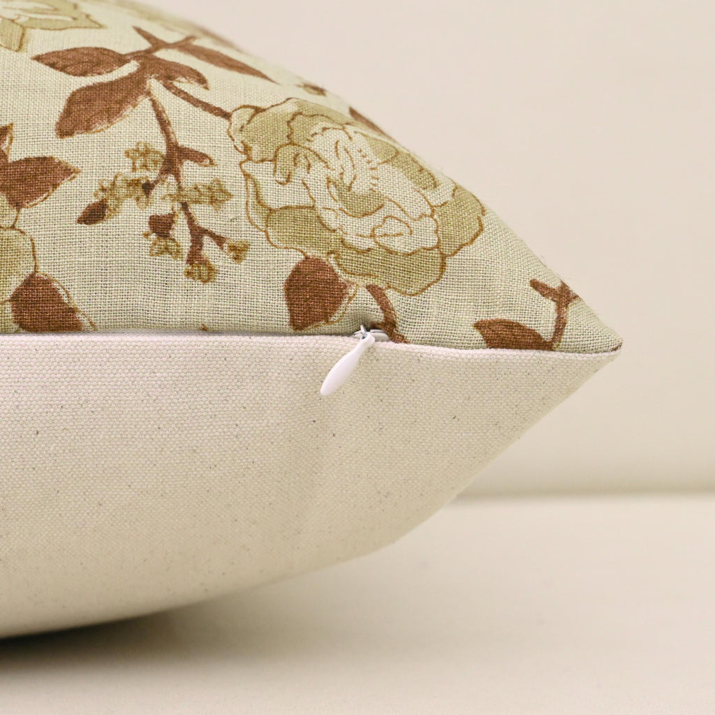 Close-up of sage rust floral block print detail on ivory linen pillow cover