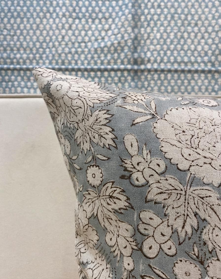 Blue-gray block print linen pillow cover styled on a sofa