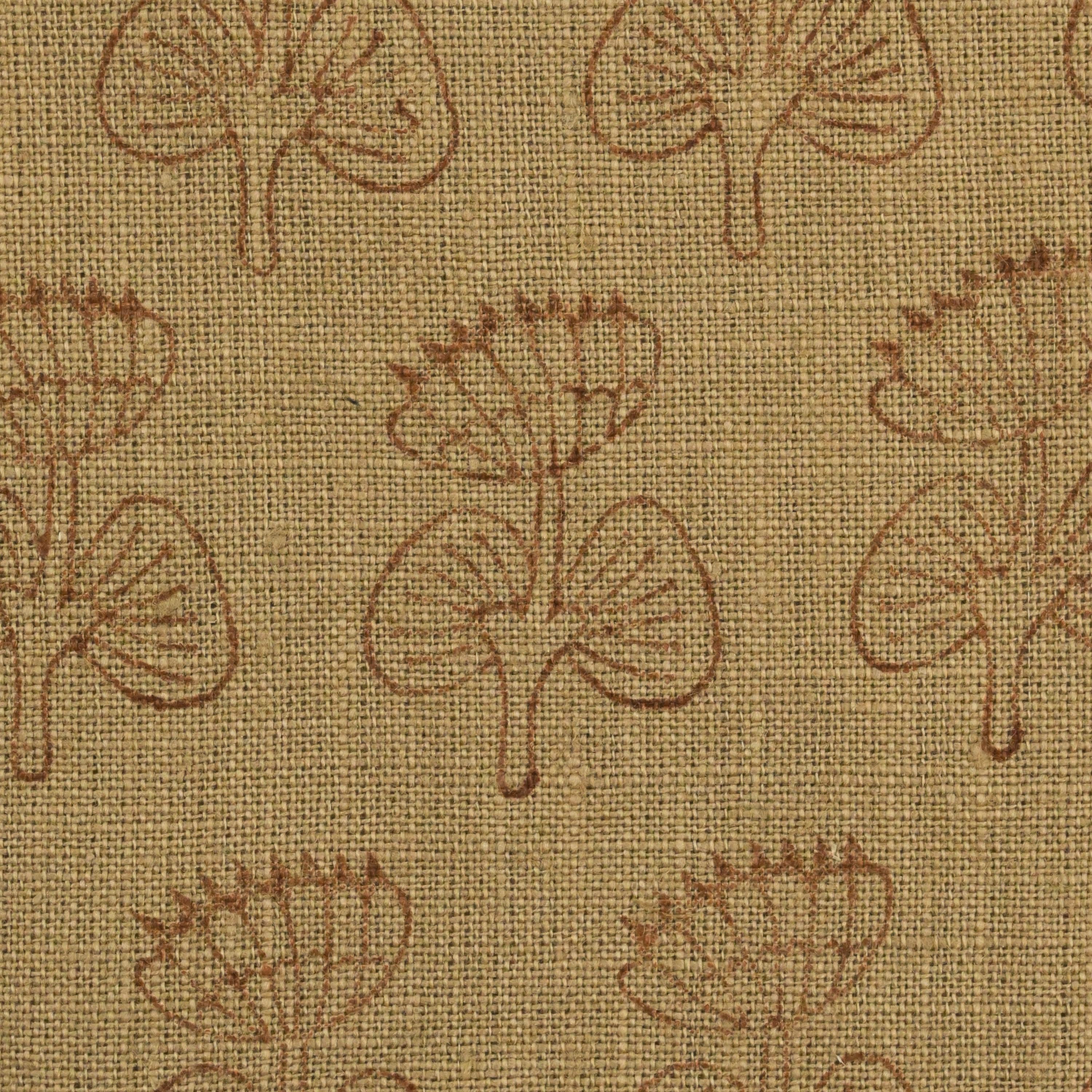 Close-up of the geometric leaf block print detail on camel linen