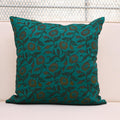 Teal wild rose vine block print linen pillow cover styled on a sofa