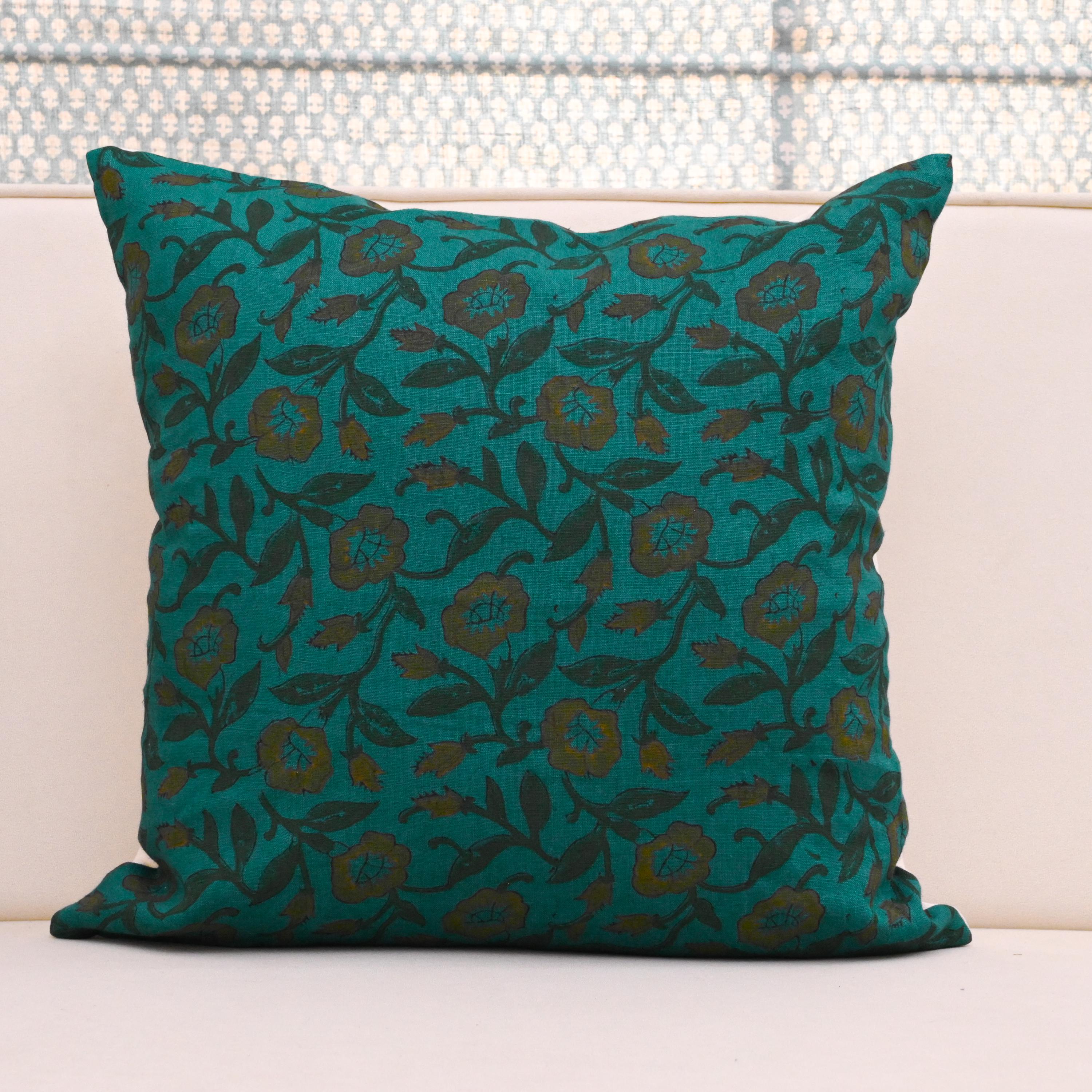 Teal wild rose vine block print linen pillow cover styled on a sofa