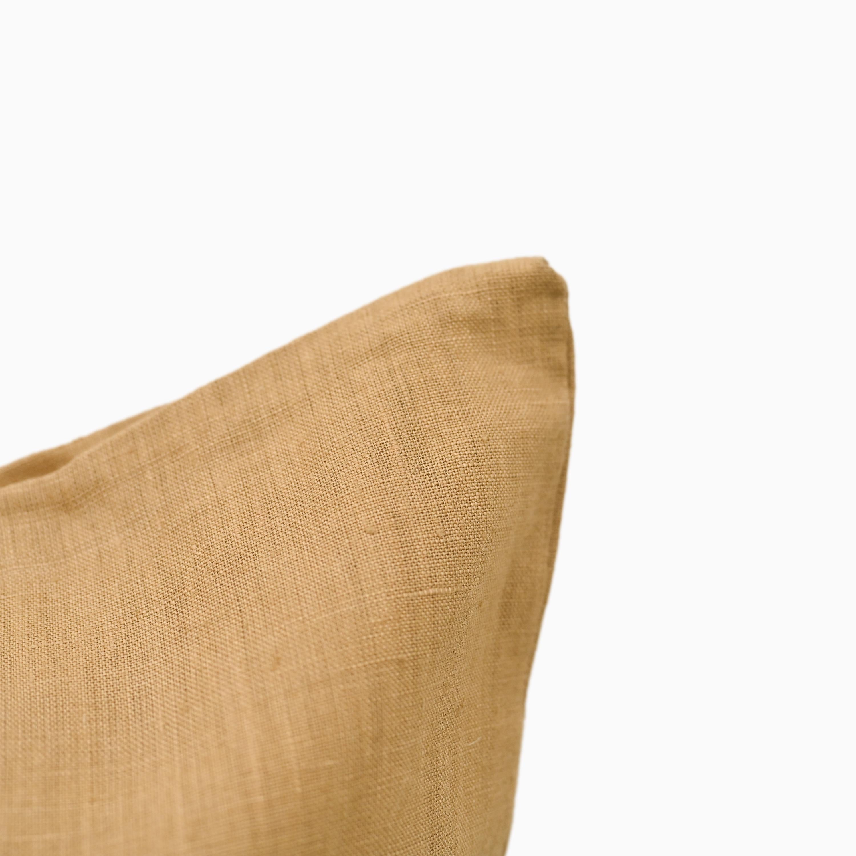 Close-up of mustard linen pillow cover fabric texture and hidden zipper