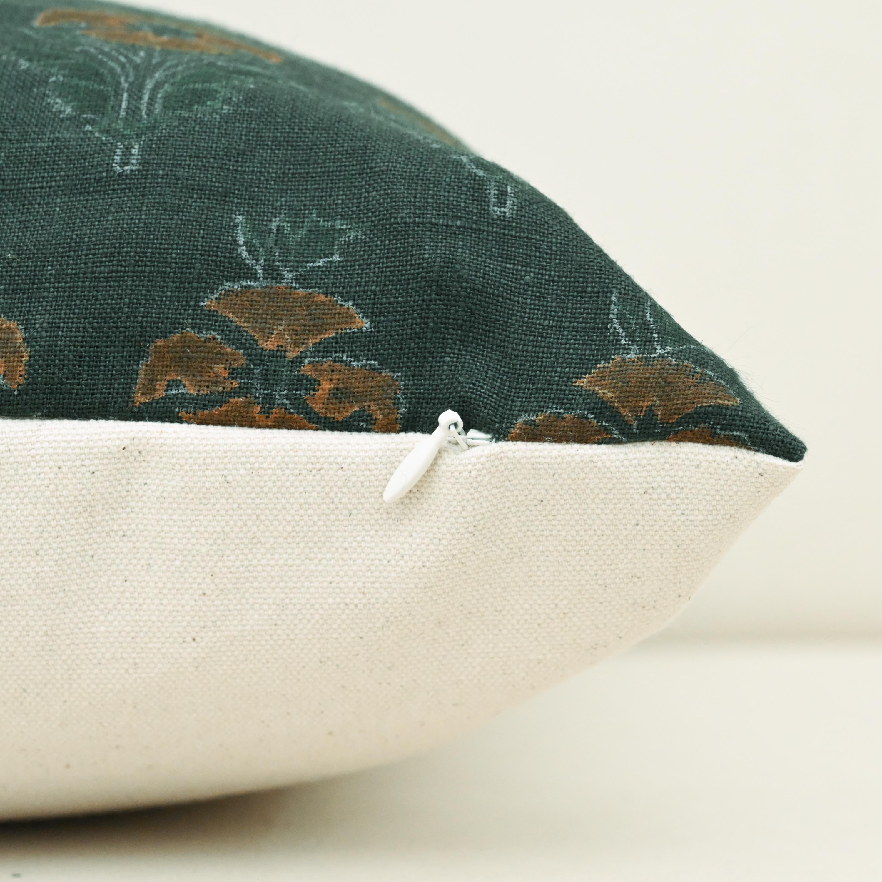 Corner detail of forest green floral buti linen pillow cover