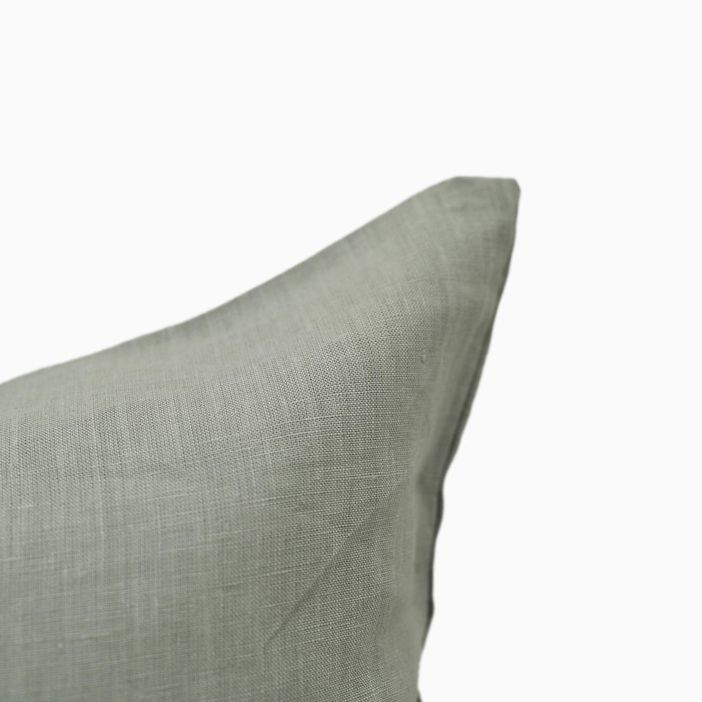Close-up of sage green linen pillow cover fabric texture