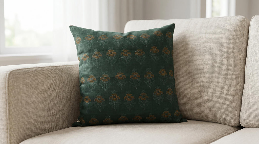 Forest green floral buti linen cushion cover on a sofa