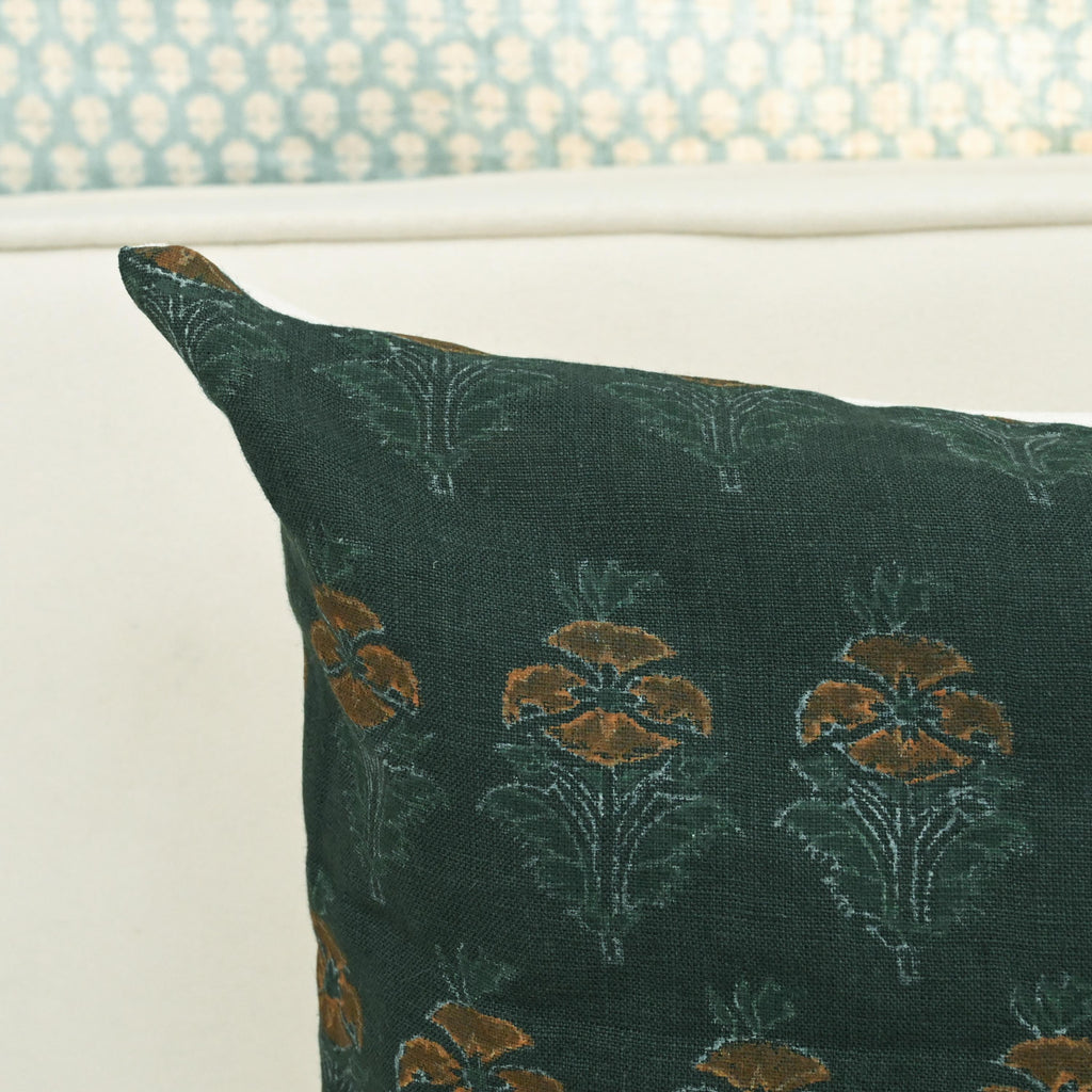 Close-up of hand block printed floral buti pattern on forest green linen