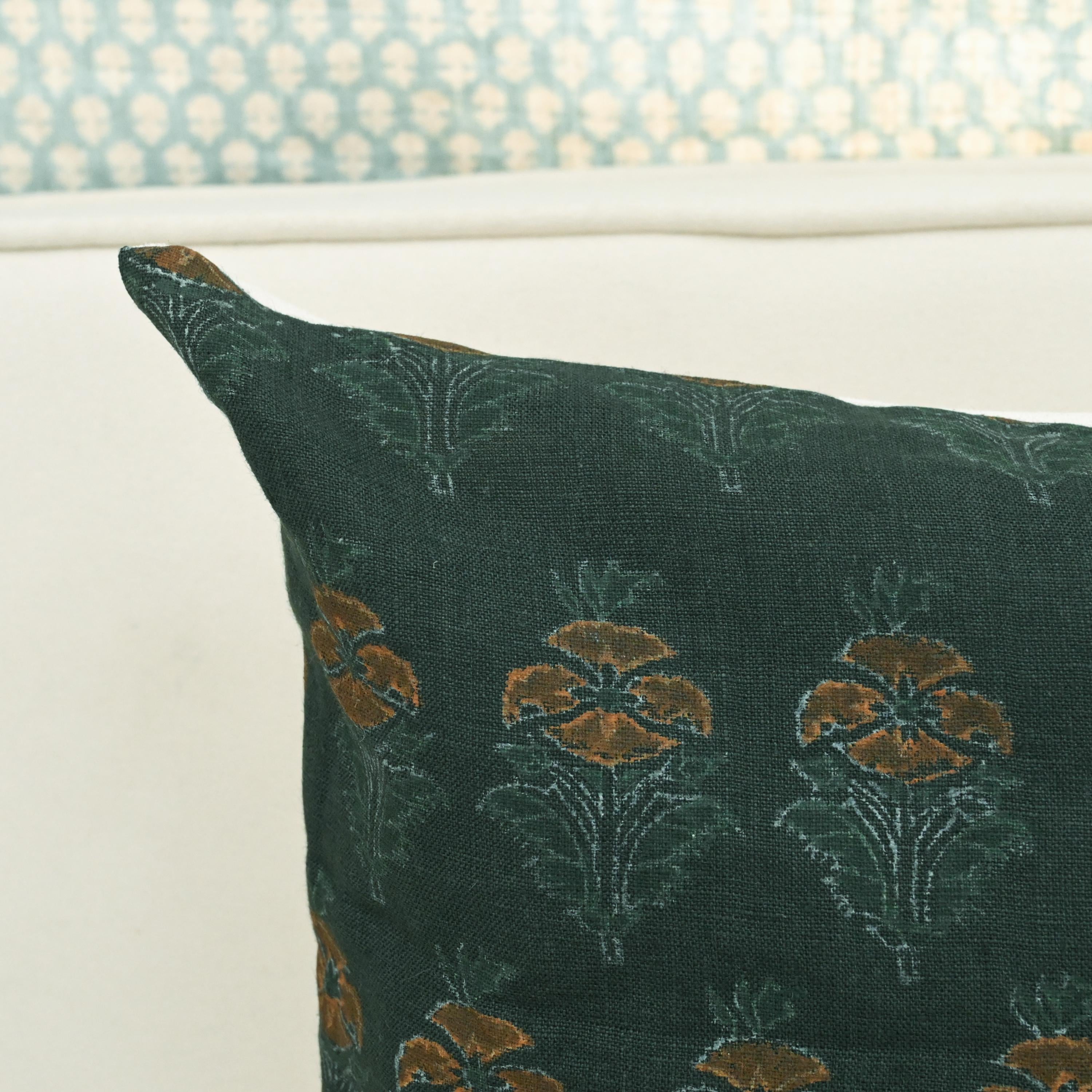 Close-up of hand block printed floral buti pattern on forest green linen