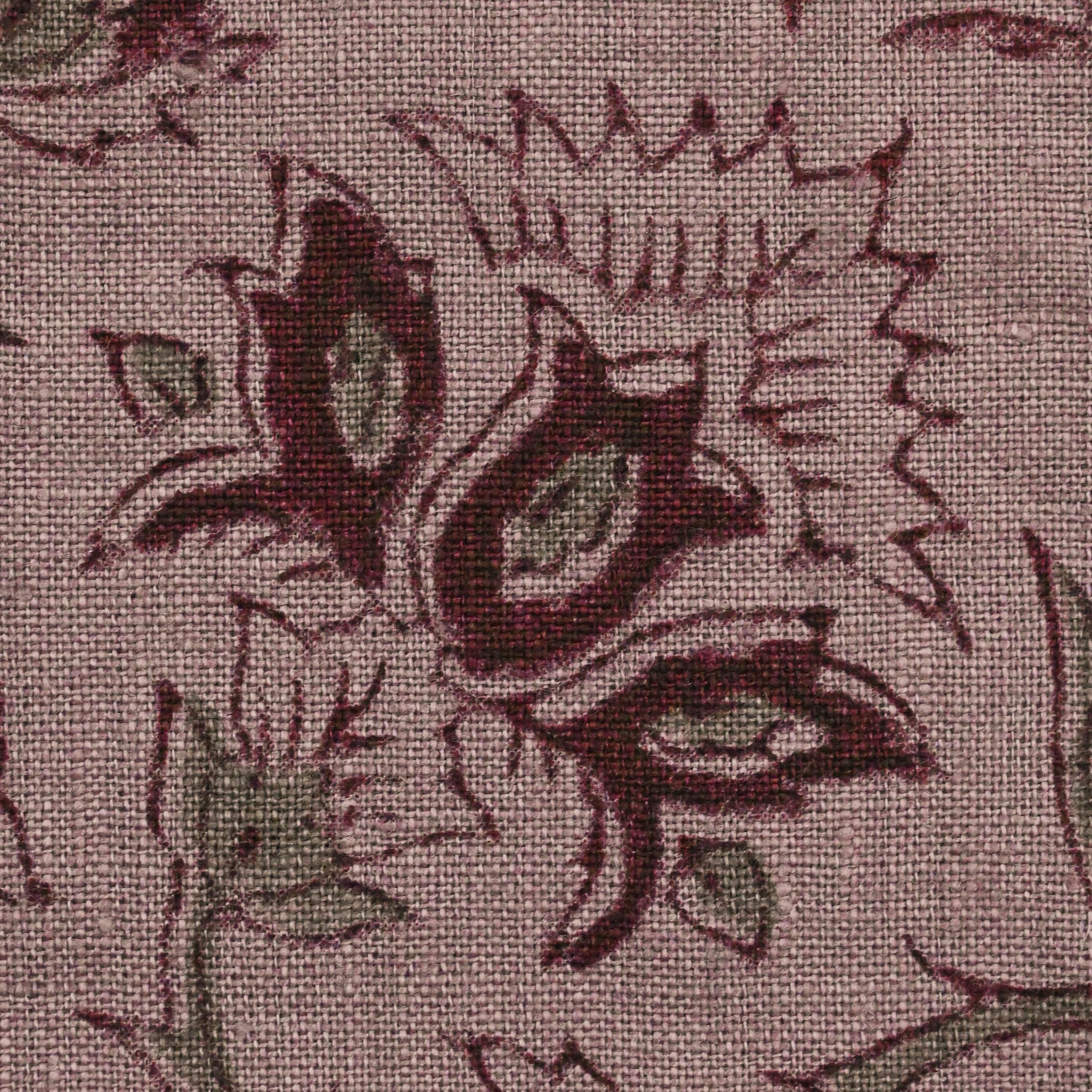 Hidden zipper and corner detail of burgundy floral linen pillow cover