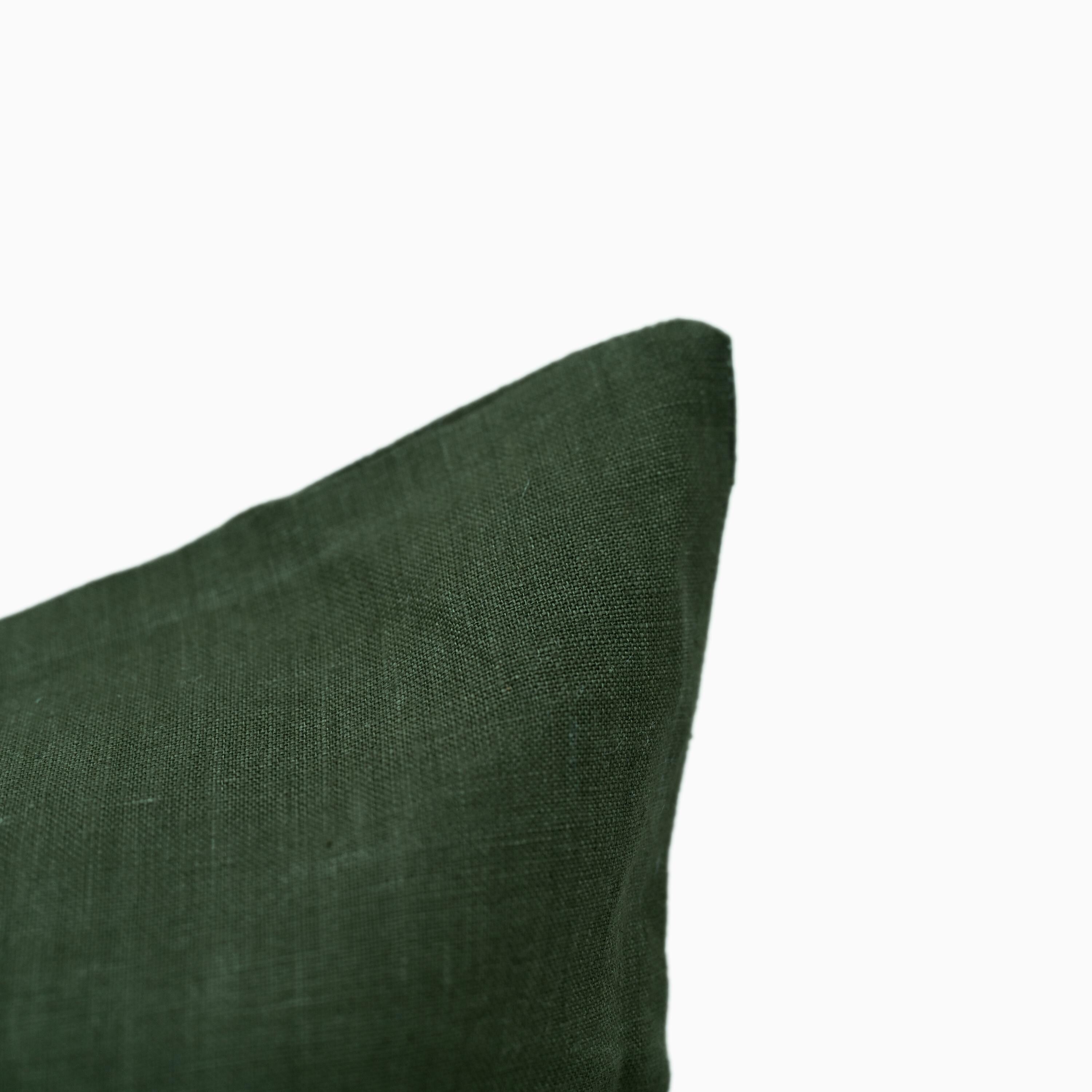 Close-up of forest green linen pillow cover fabric texture