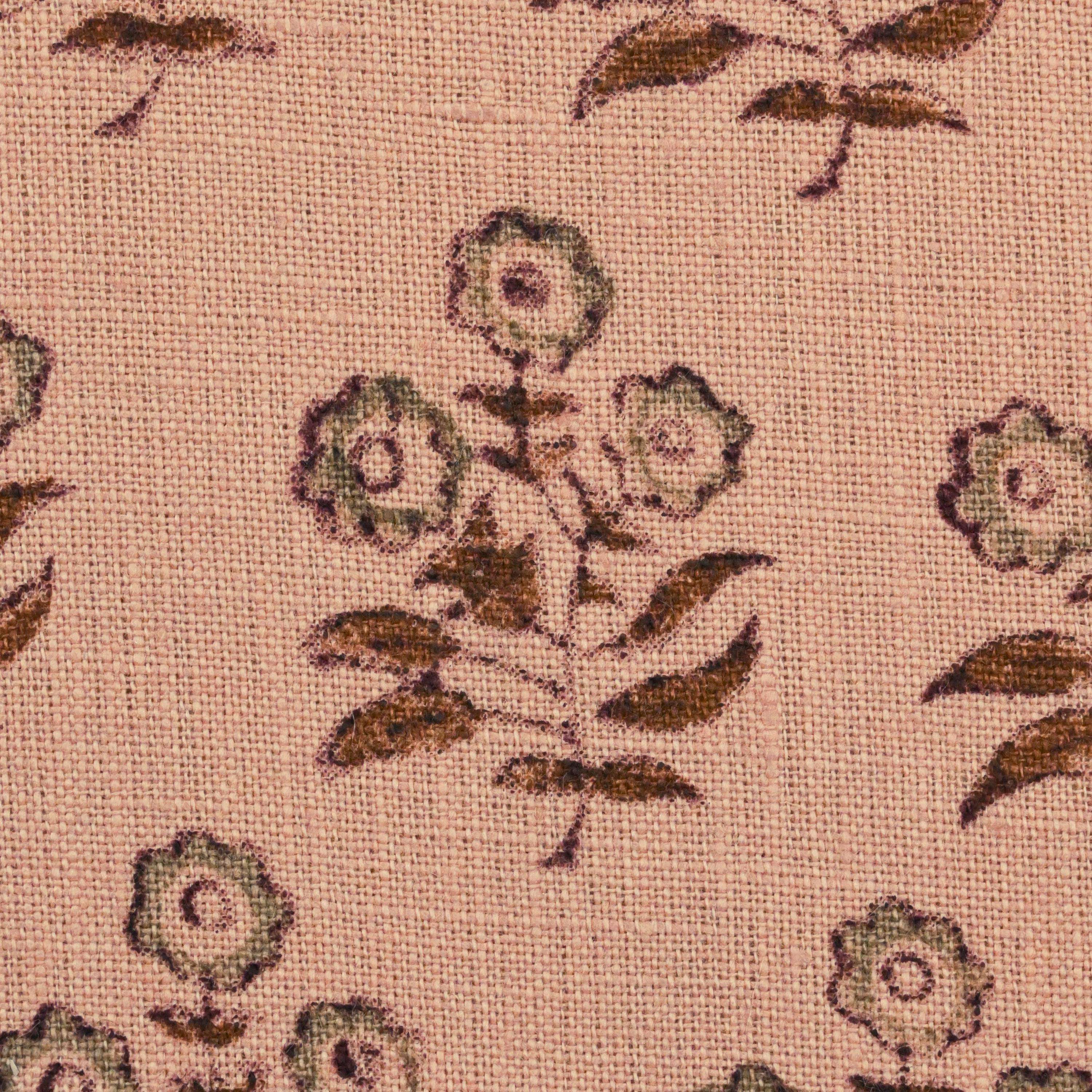Close-up of the chestnut brown floral buti block print on peach linen