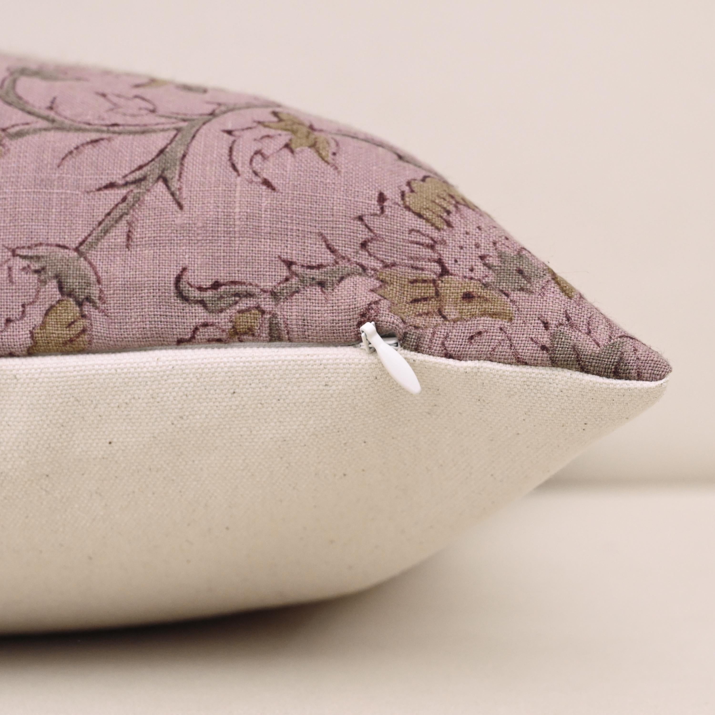 Close-up of gold floral block print detail on mauve linen pillow cover