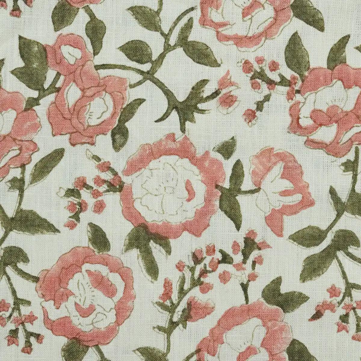 Blush pink floral block print linen cushion cover styled on a sofa