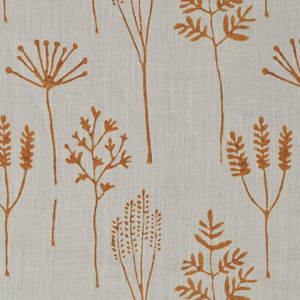 Rust botanical block print linen pillow cover styled on a sofa