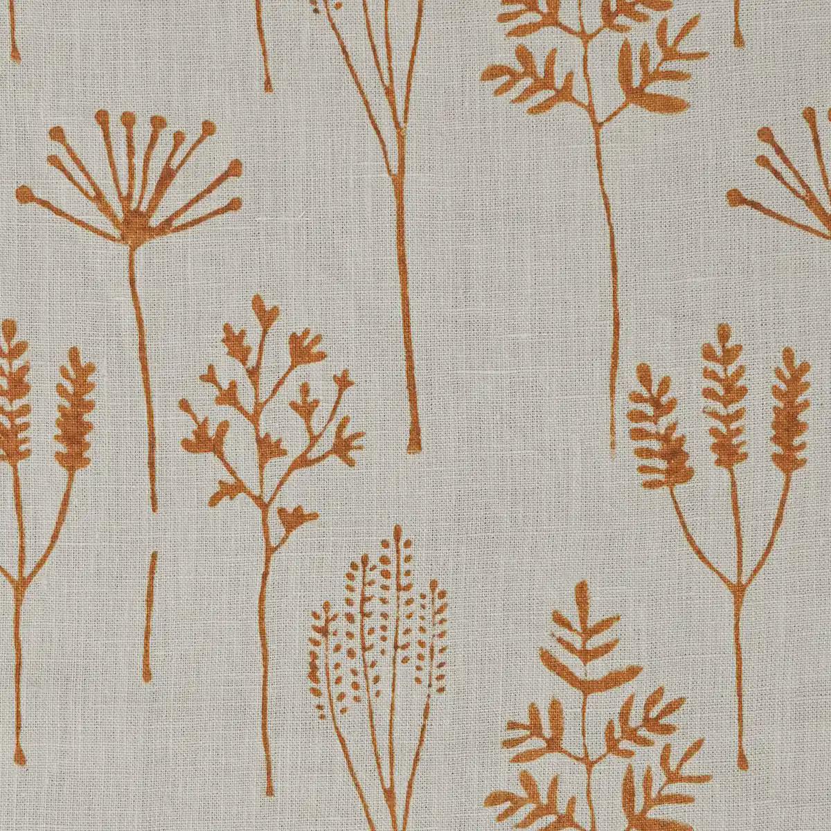 Rust botanical block print linen pillow cover styled on a sofa