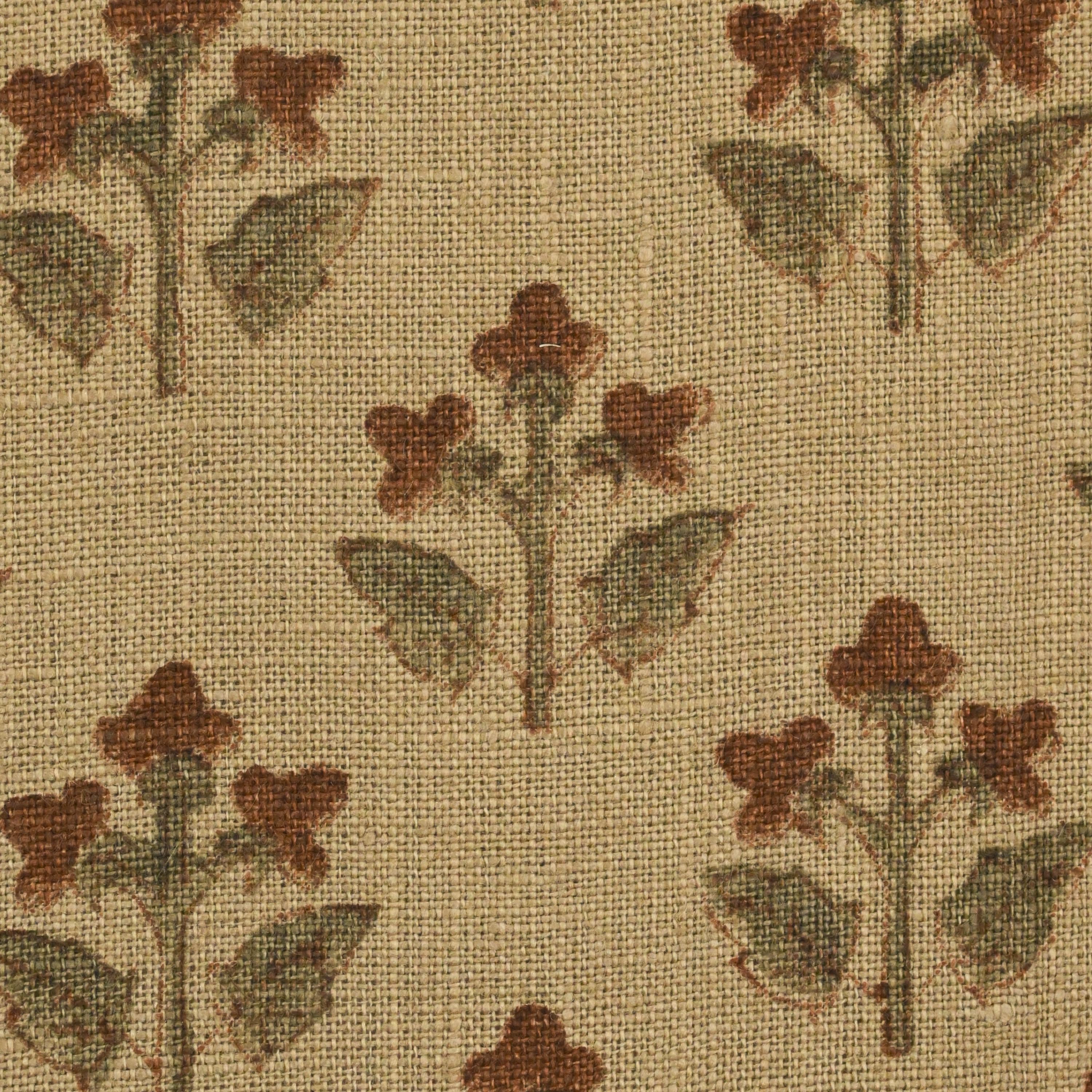 Close-up of the rust brown floral buti block print detail on camel linen