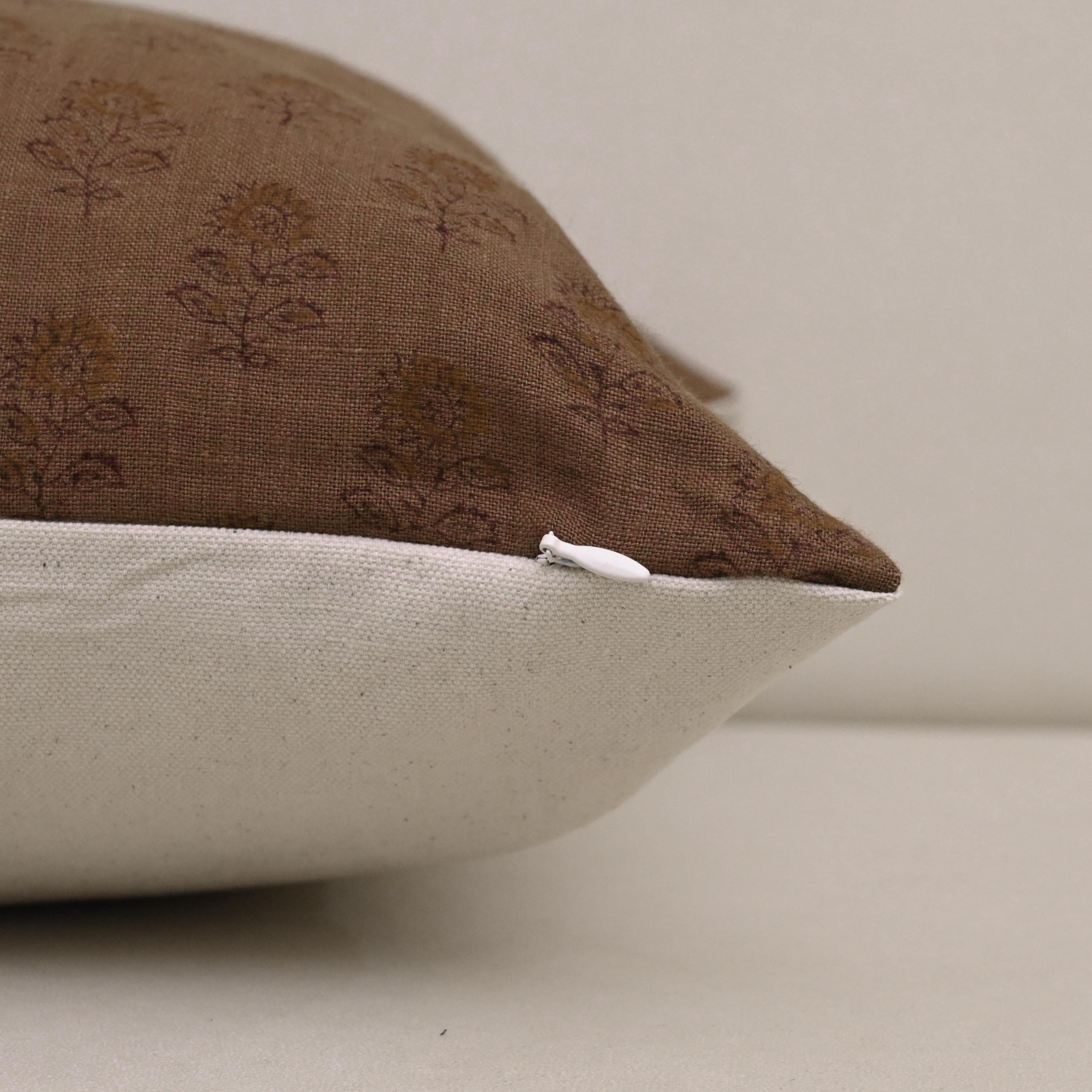 Corner detail of brown floral buta linen pillow cover
