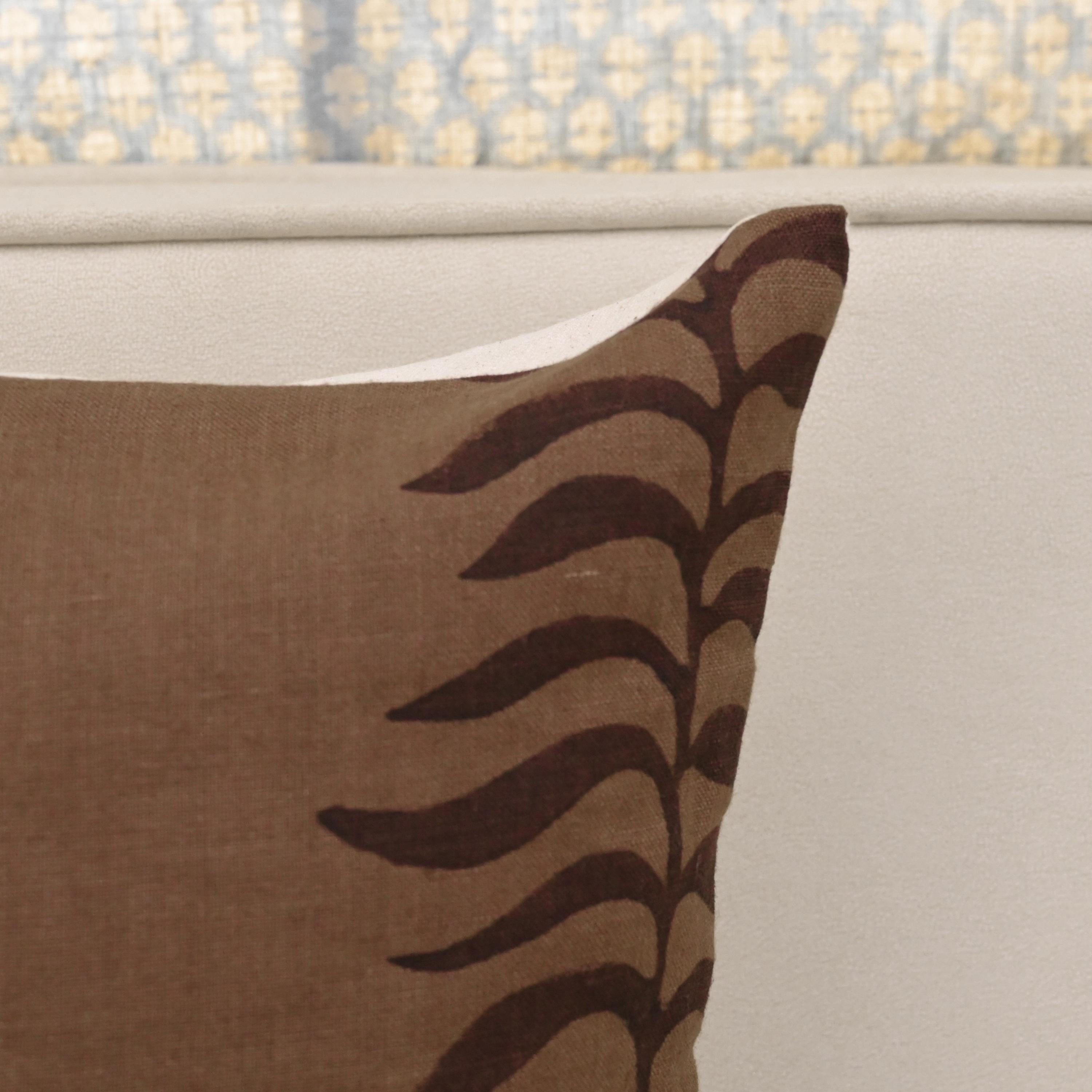 Close-up of hand block printed fern trail pattern on chestnut brown linen