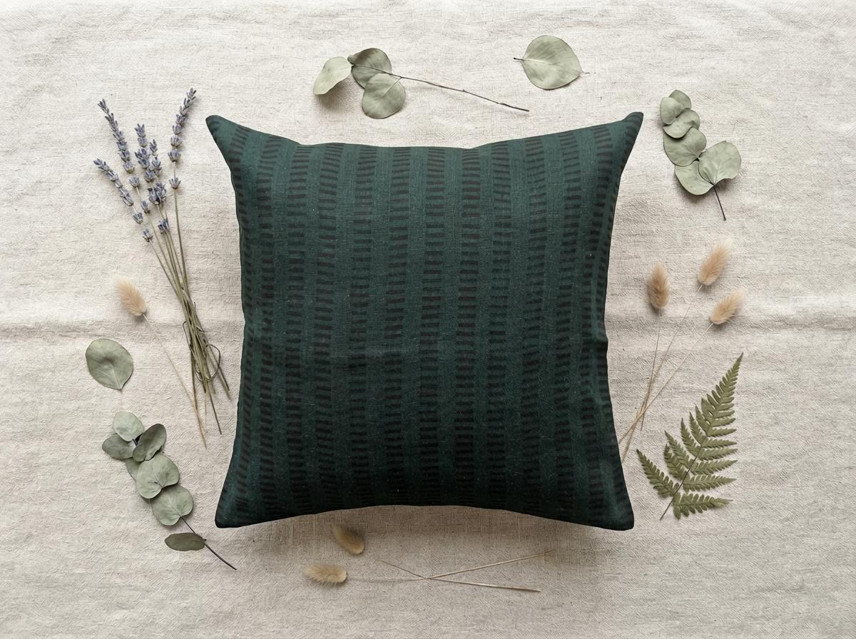 Forest green geometric stripe linen cushion cover on a sofa