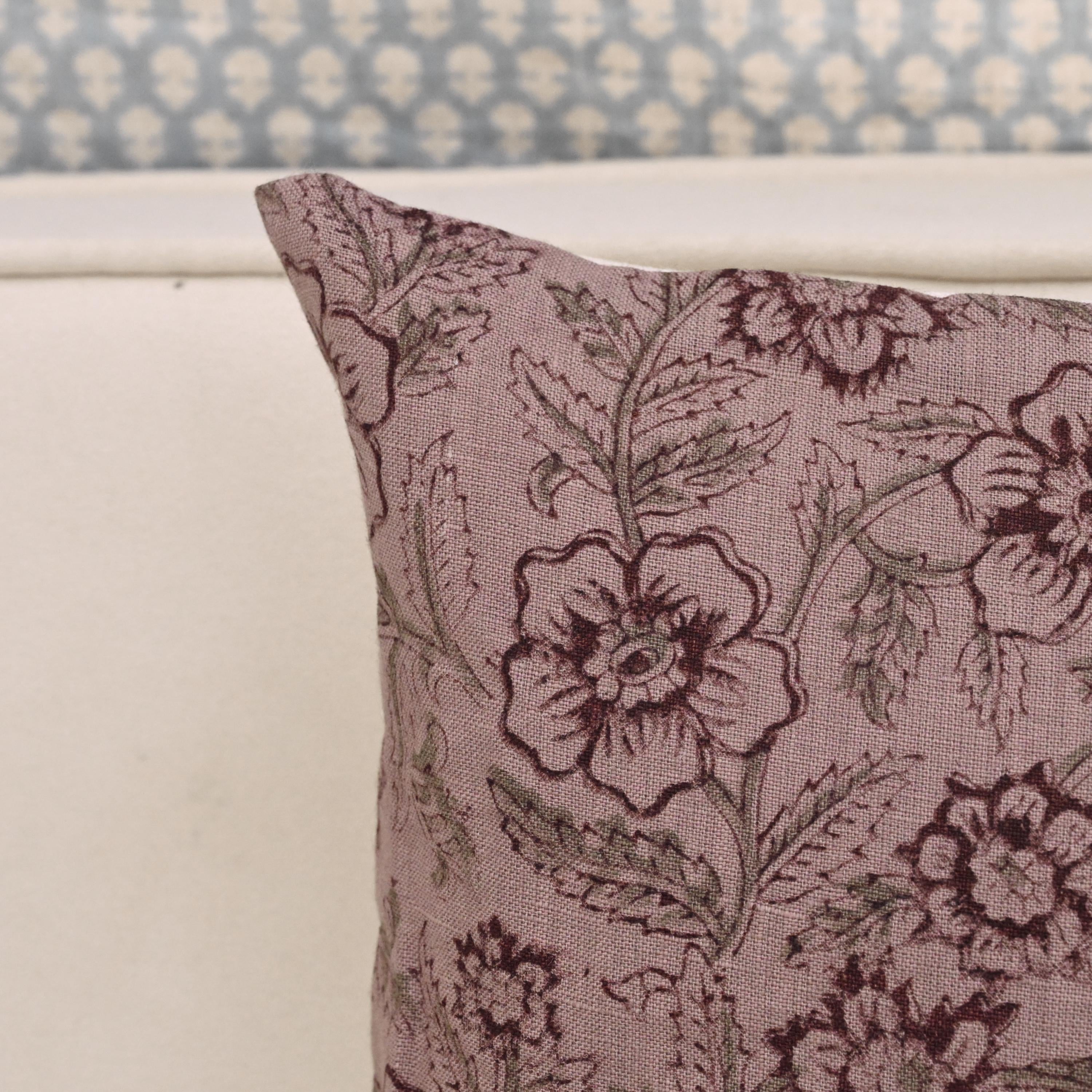 Mauve floral linen throw pillow cover styled on a sofa