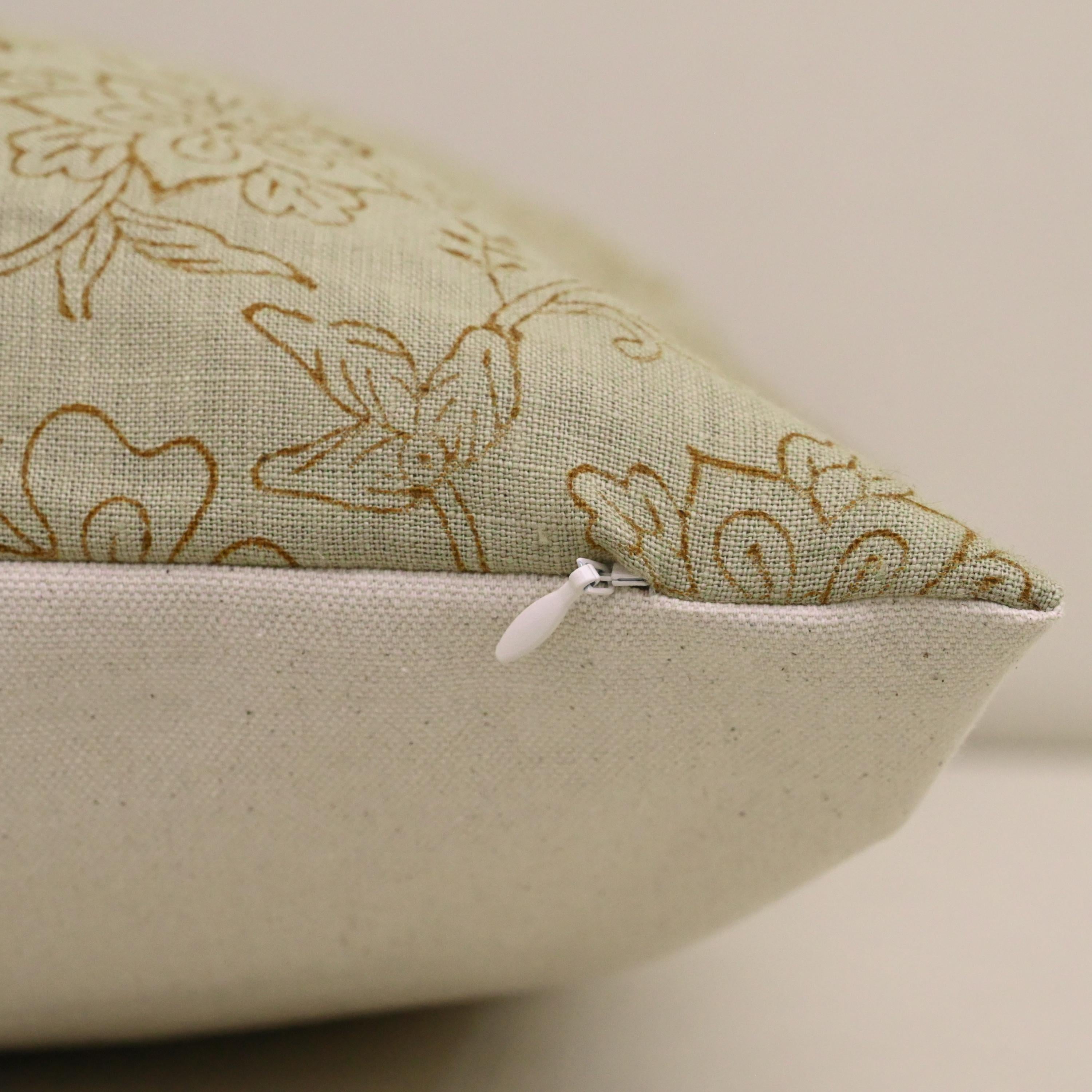 Close-up of hand block printed chintz jaal vine pattern on sage linen