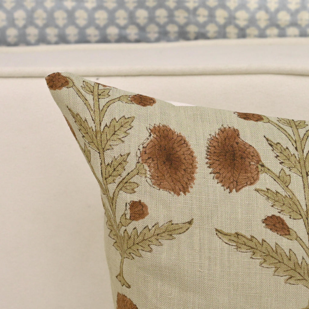 Rust dahlia linen pillow cover styled on a sofa
