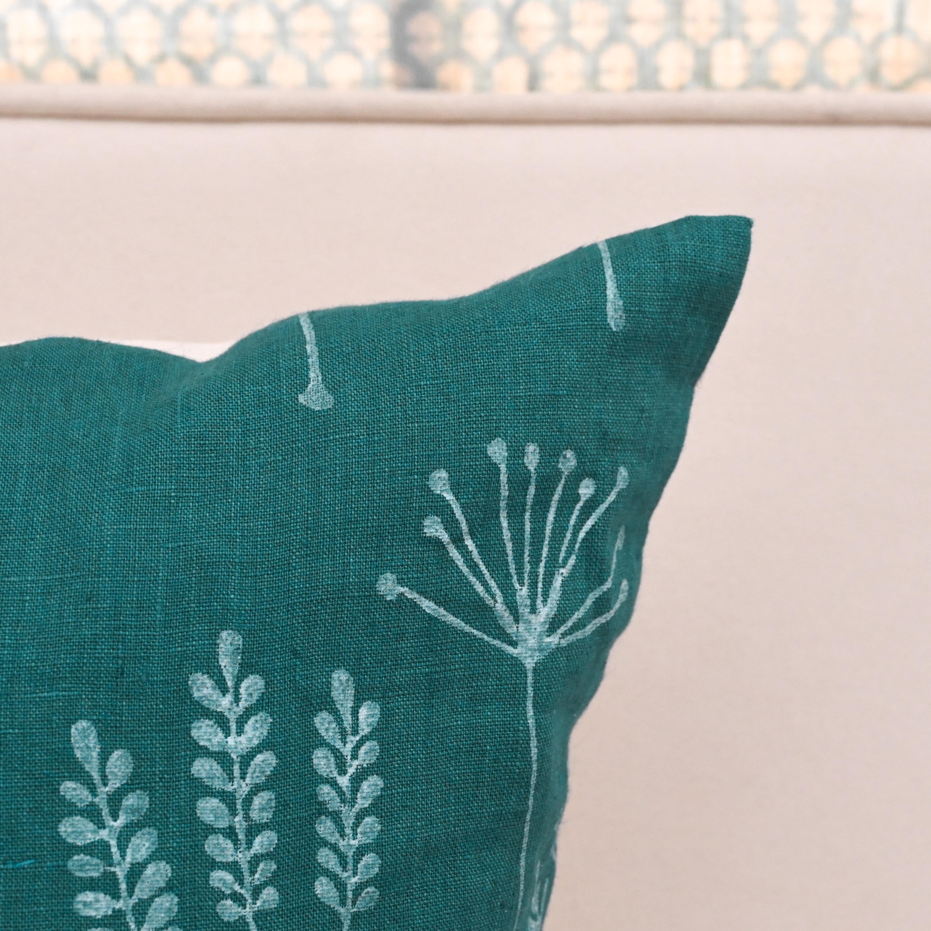 Close-up of hand block printed wild meadow sprigs on teal linen