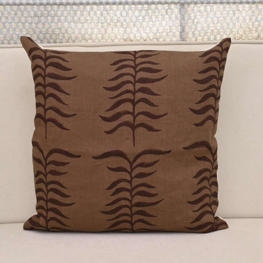 Chestnut brown fern trail block print linen pillow cover styled on a sofa