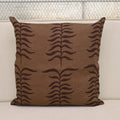 Chestnut brown fern trail block print linen pillow cover styled on a sofa