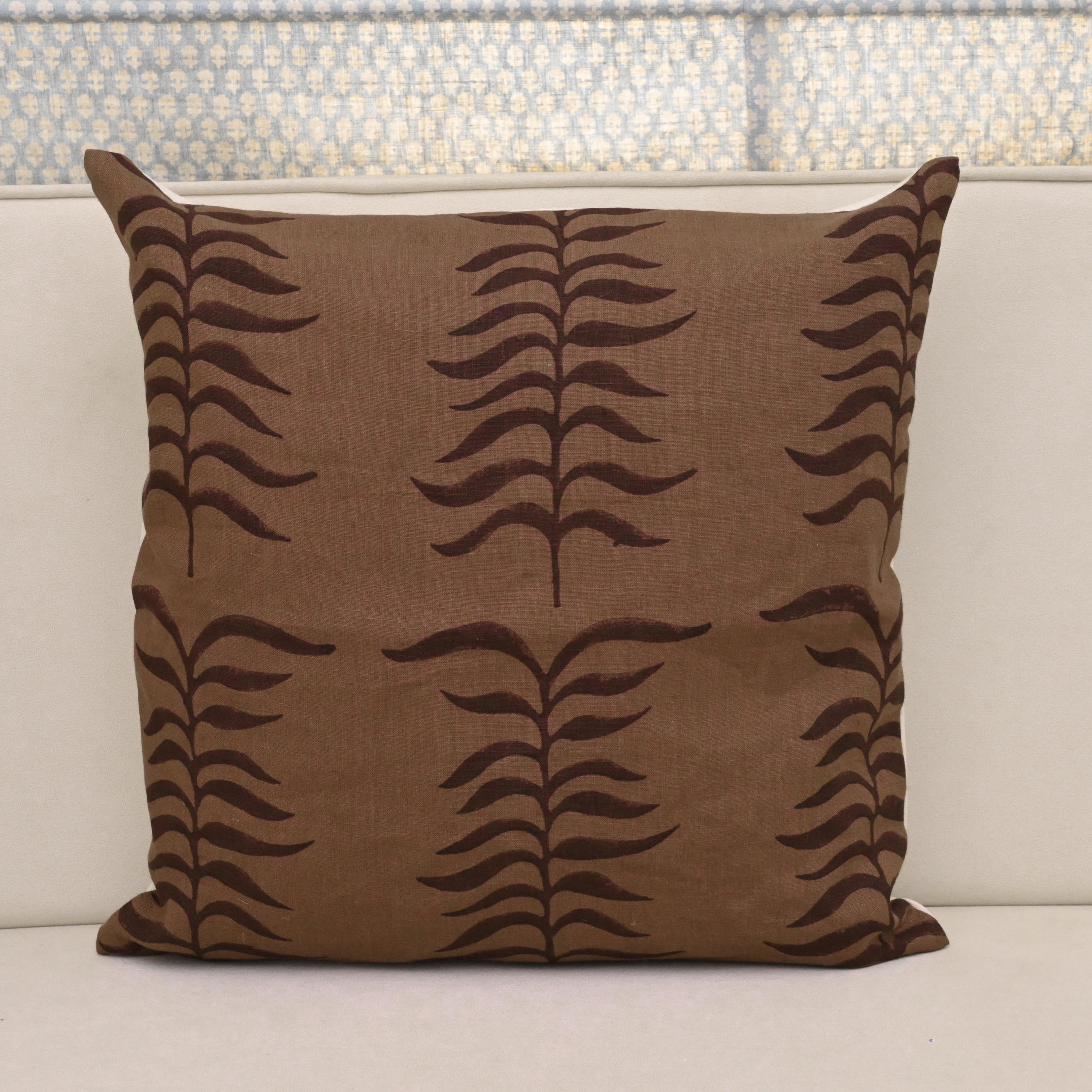 Chestnut brown fern trail block print linen pillow cover styled on a sofa