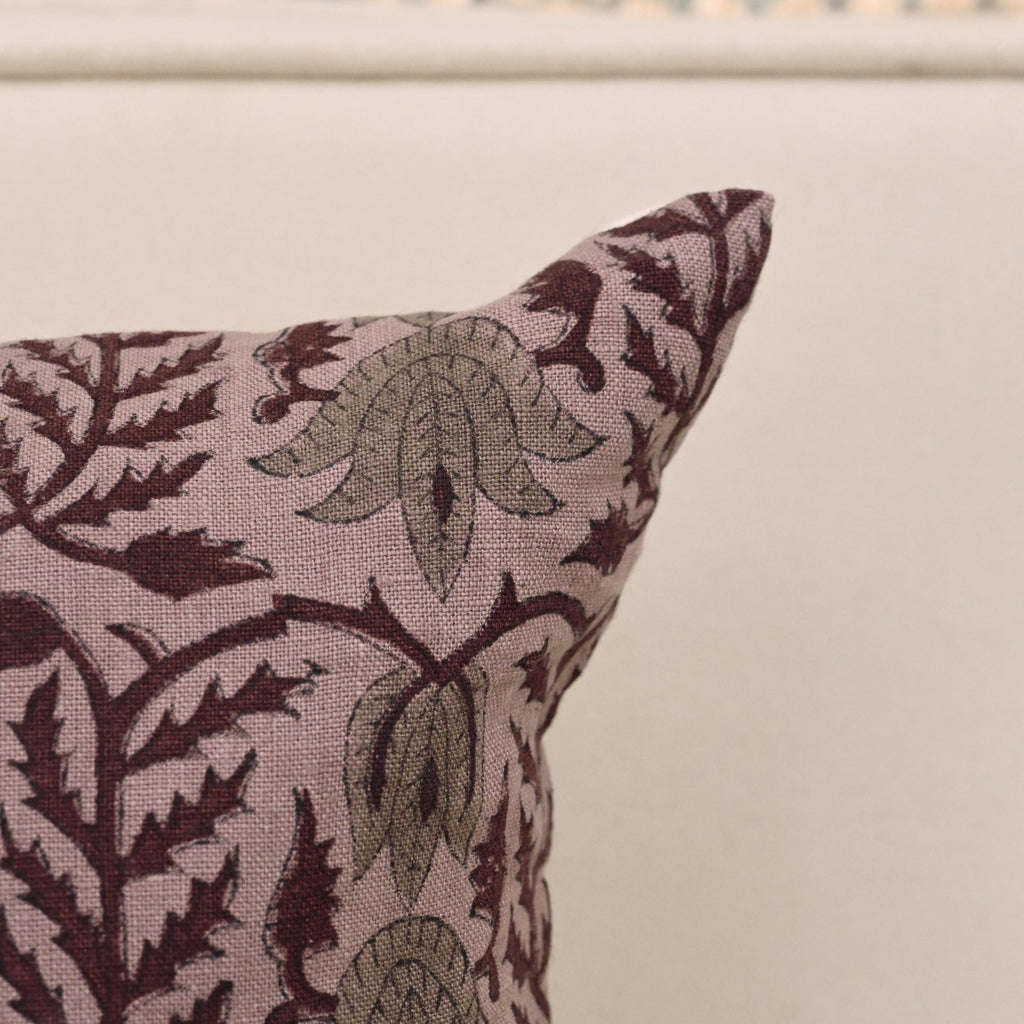 Mauve damask block print linen pillow cover styled on a sofa