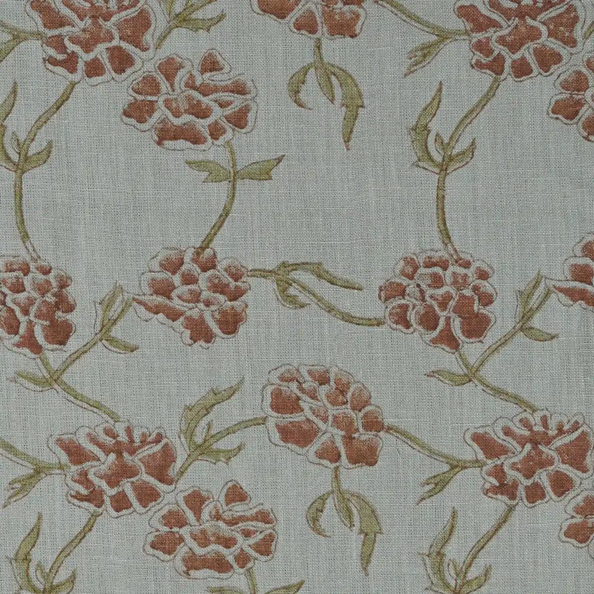 Close-up of terracotta floral block print pattern on dusty blue linen cushion cover