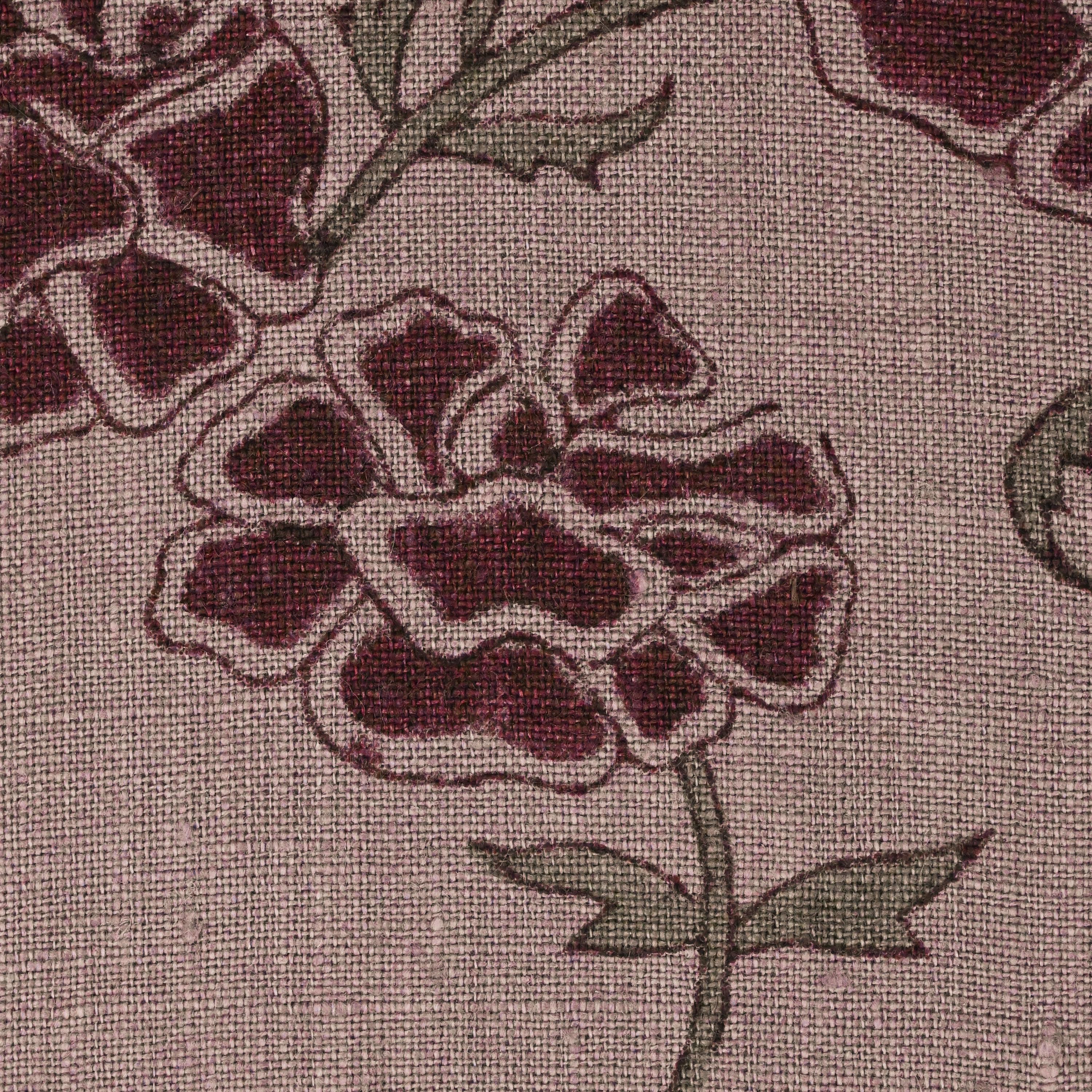 Close-up of the burgundy carnation block print detail on mauve linen pillow cover
