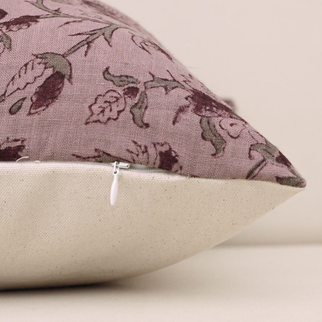 Close-up of burgundy floral block print detail on mauve linen pillow cover