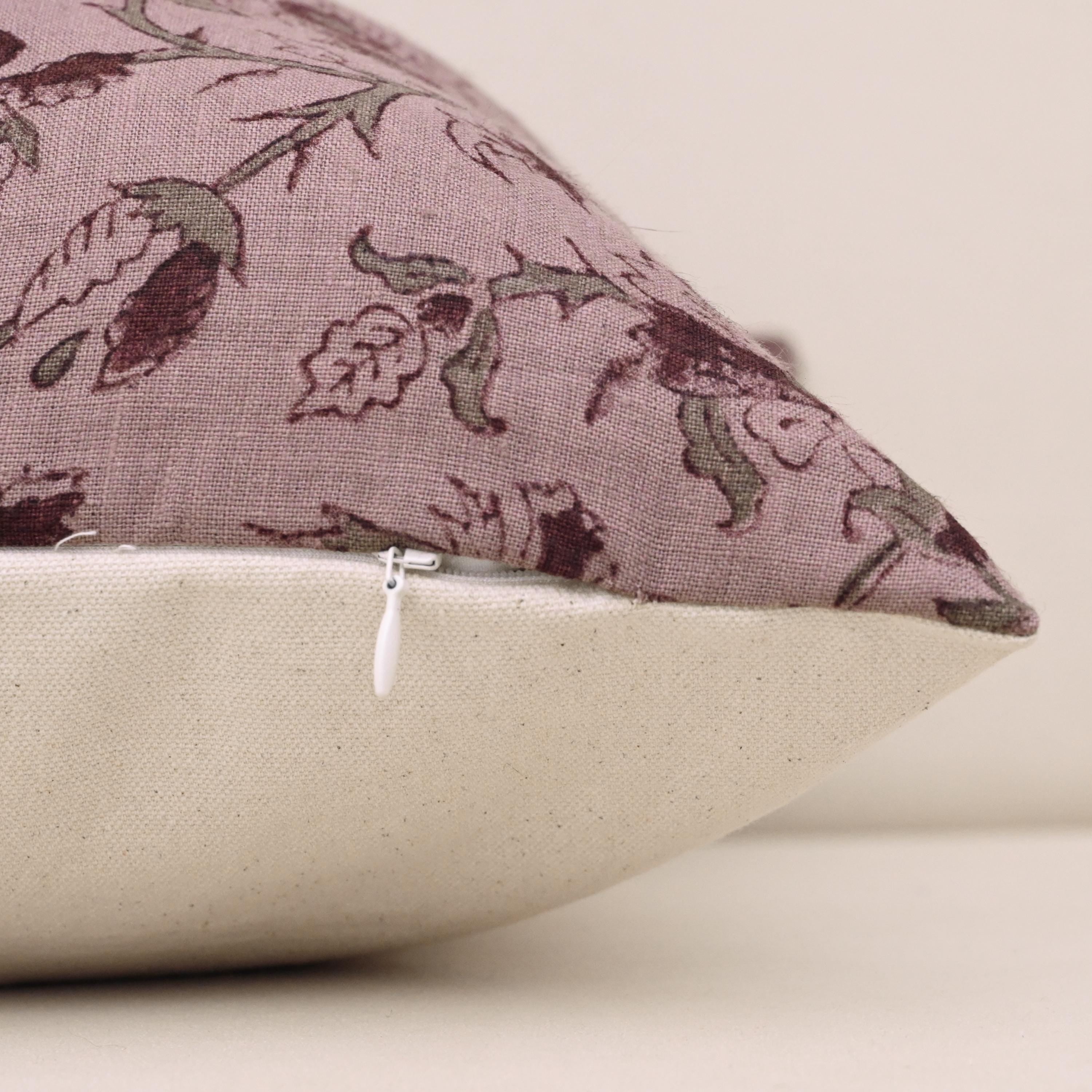 Close-up of burgundy floral block print detail on mauve linen pillow cover
