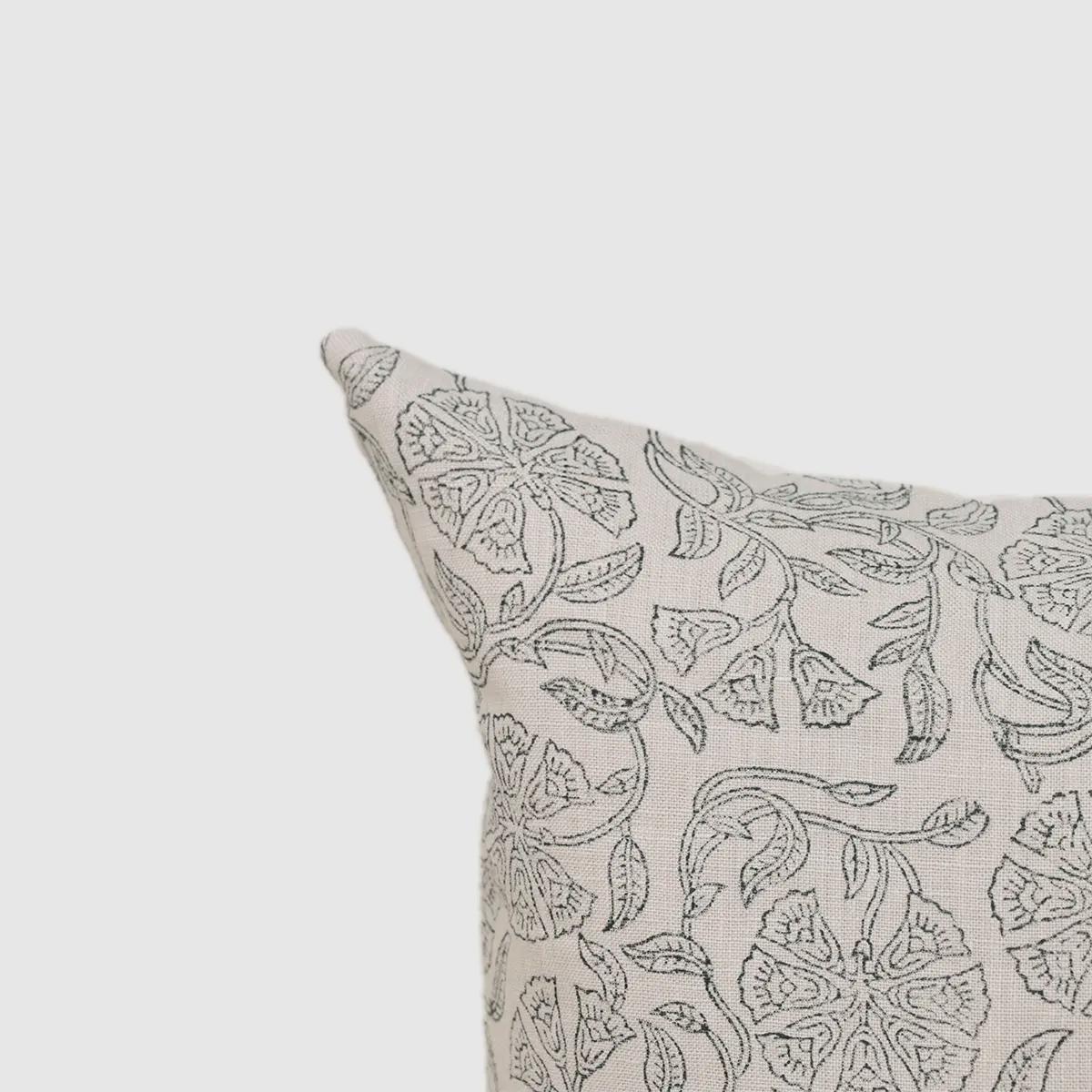 Ashen grey floral linen pillow cover styled on a sofa