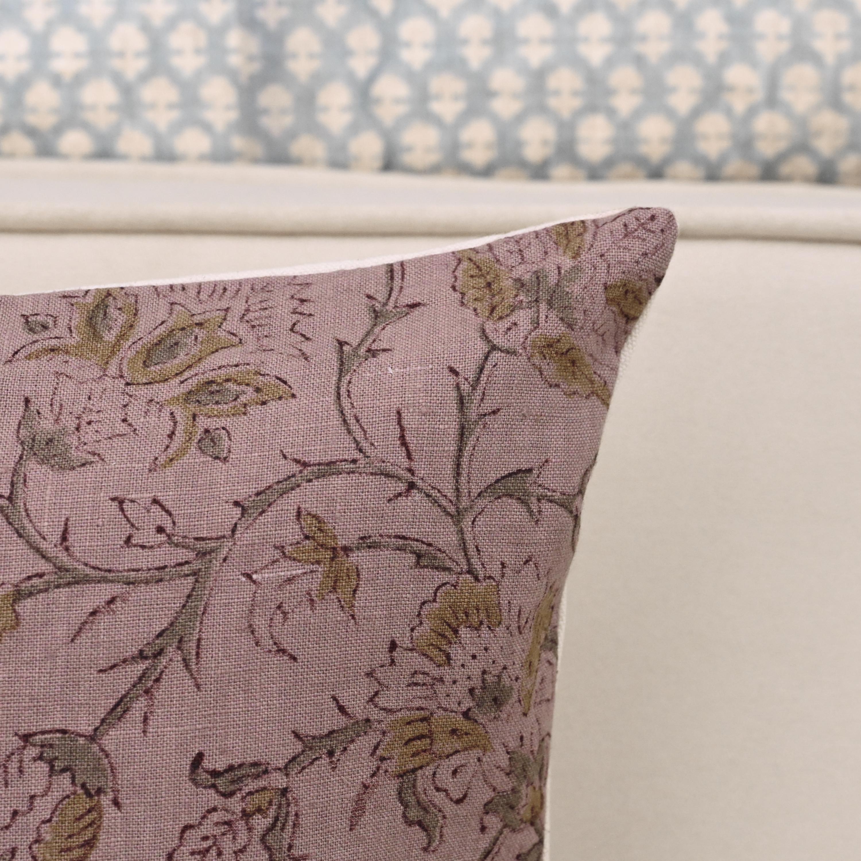 Dusty rose mauve floral linen pillow cover styled on a sofa