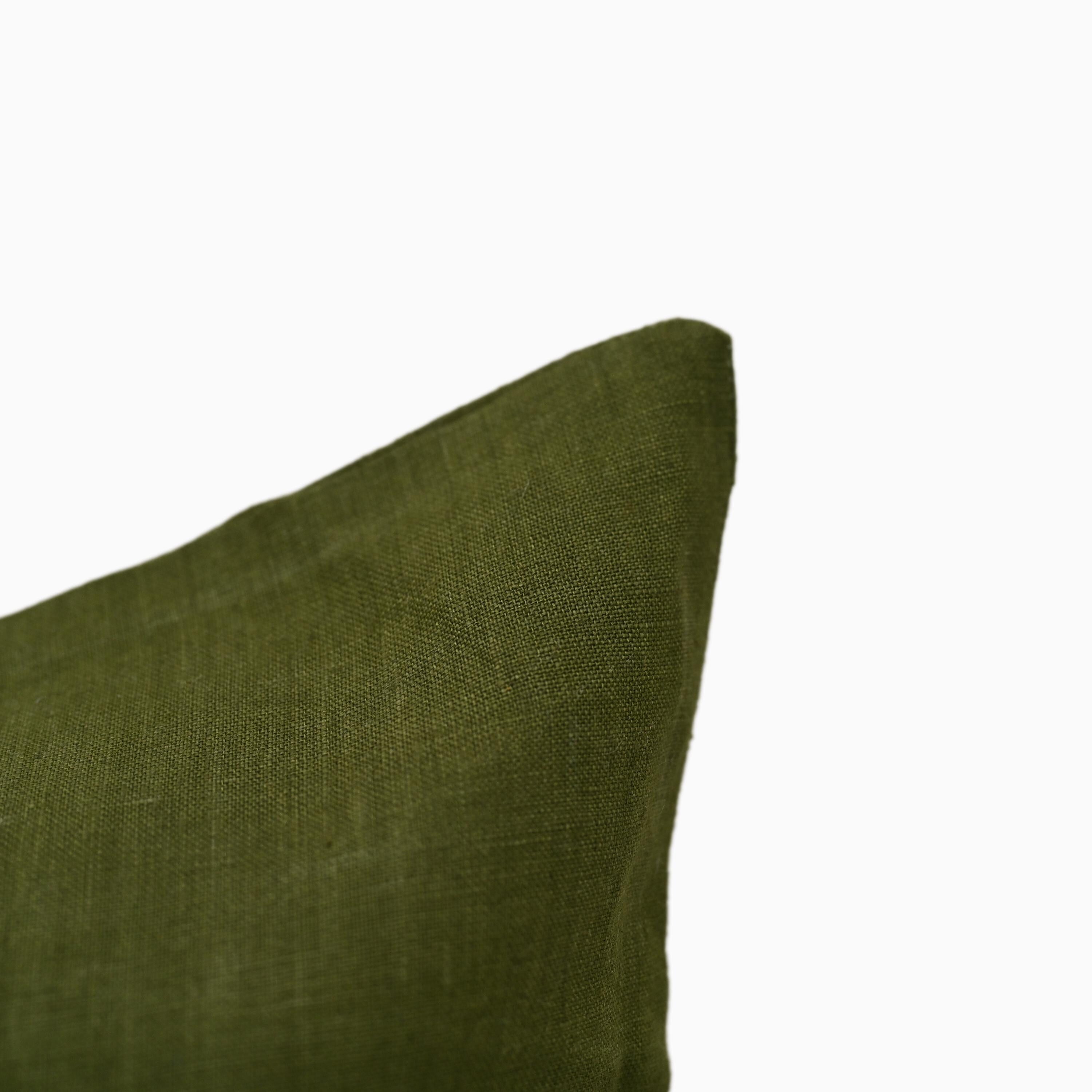 Close-up of olive green linen pillow cover fabric and hidden zipper edge