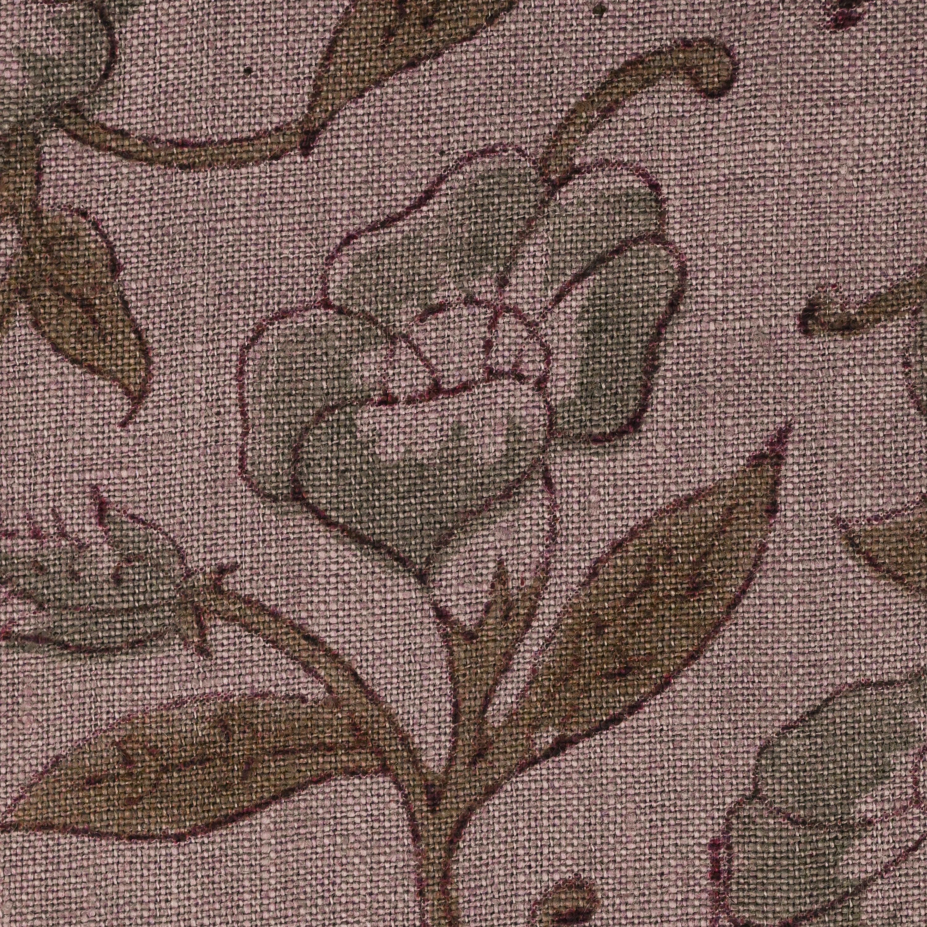 Close-up of the sage grey floral vine block print detail on mauve linen