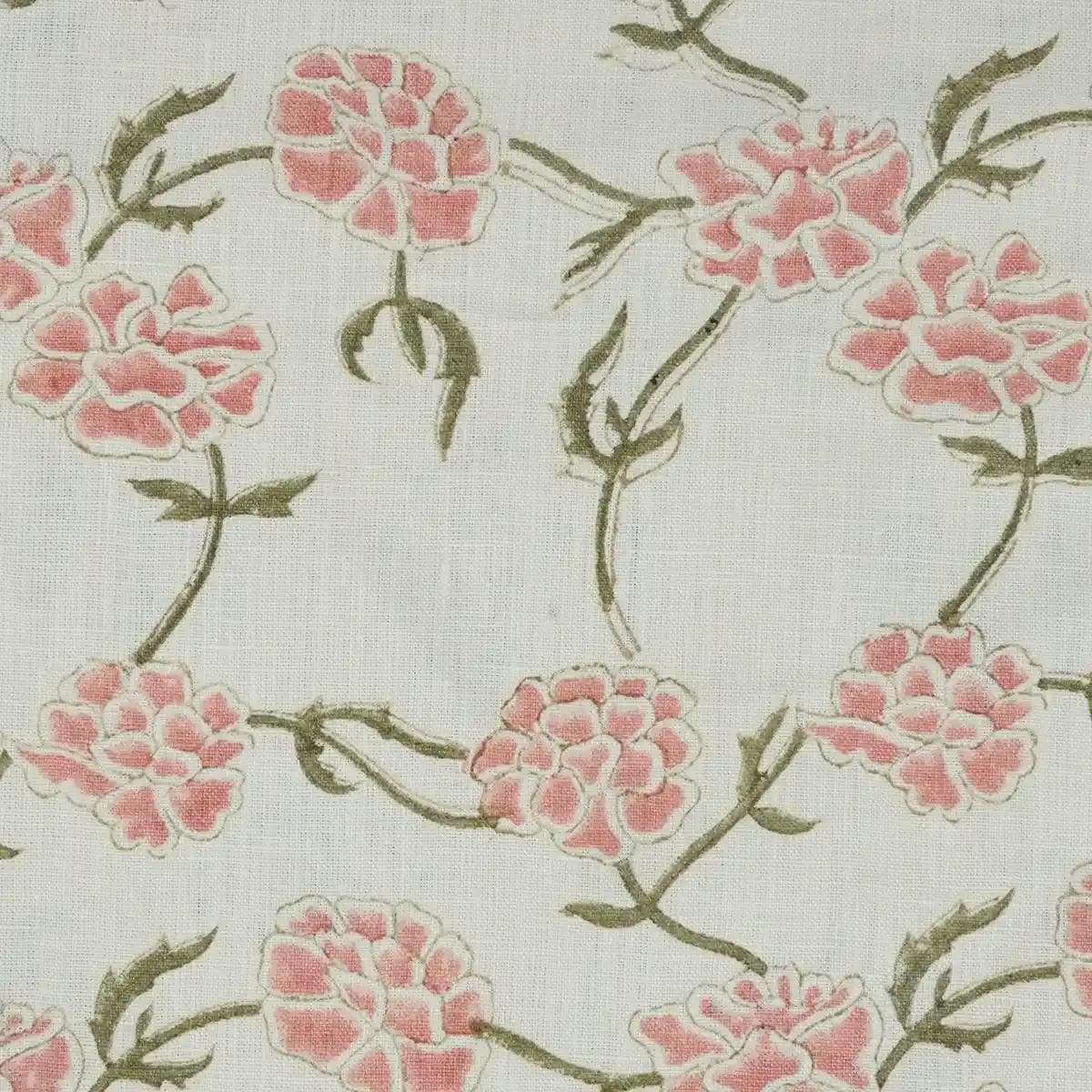Blush pink floral block print linen cushion cover styled on a sofa