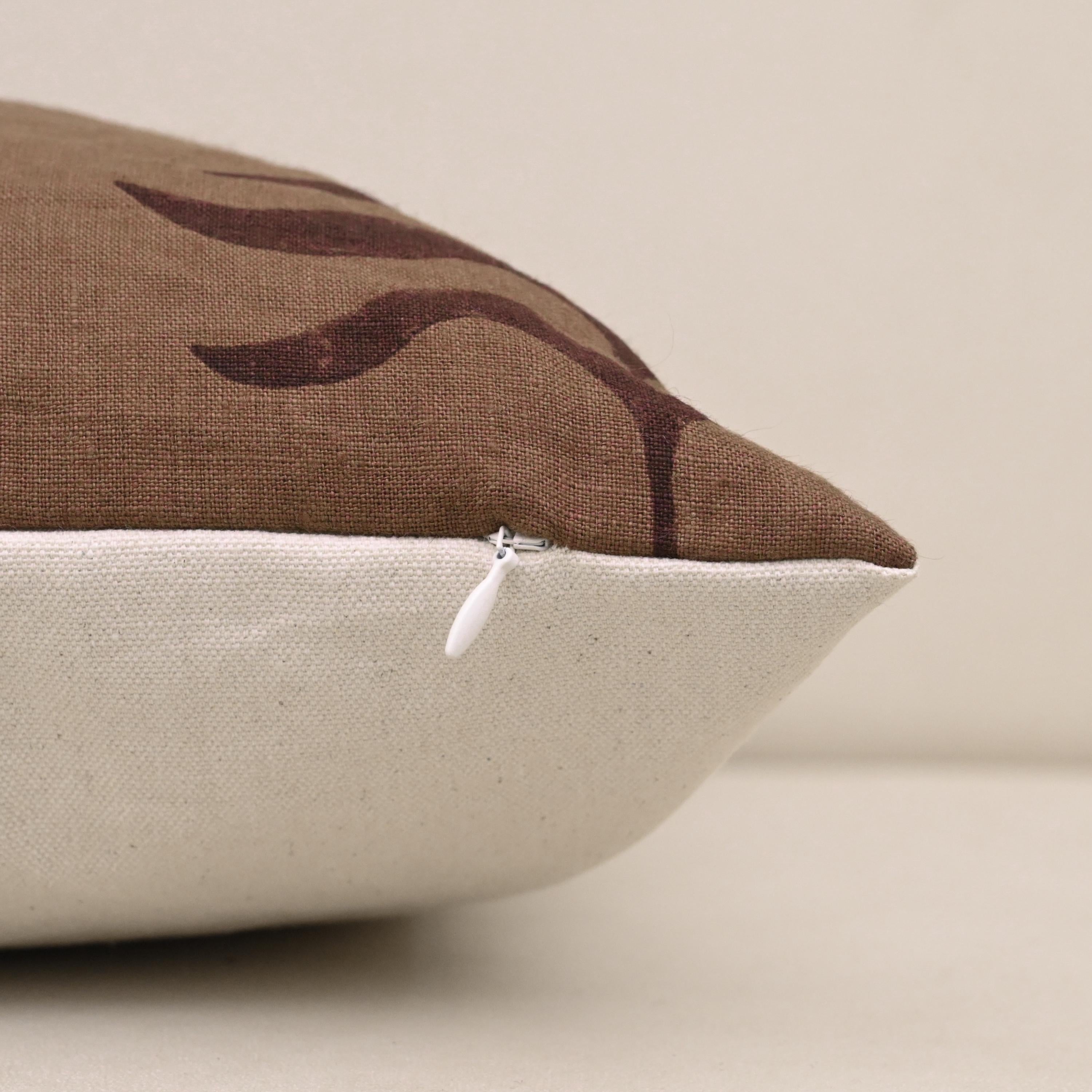 Corner detail of chestnut brown fern trail linen pillow cover