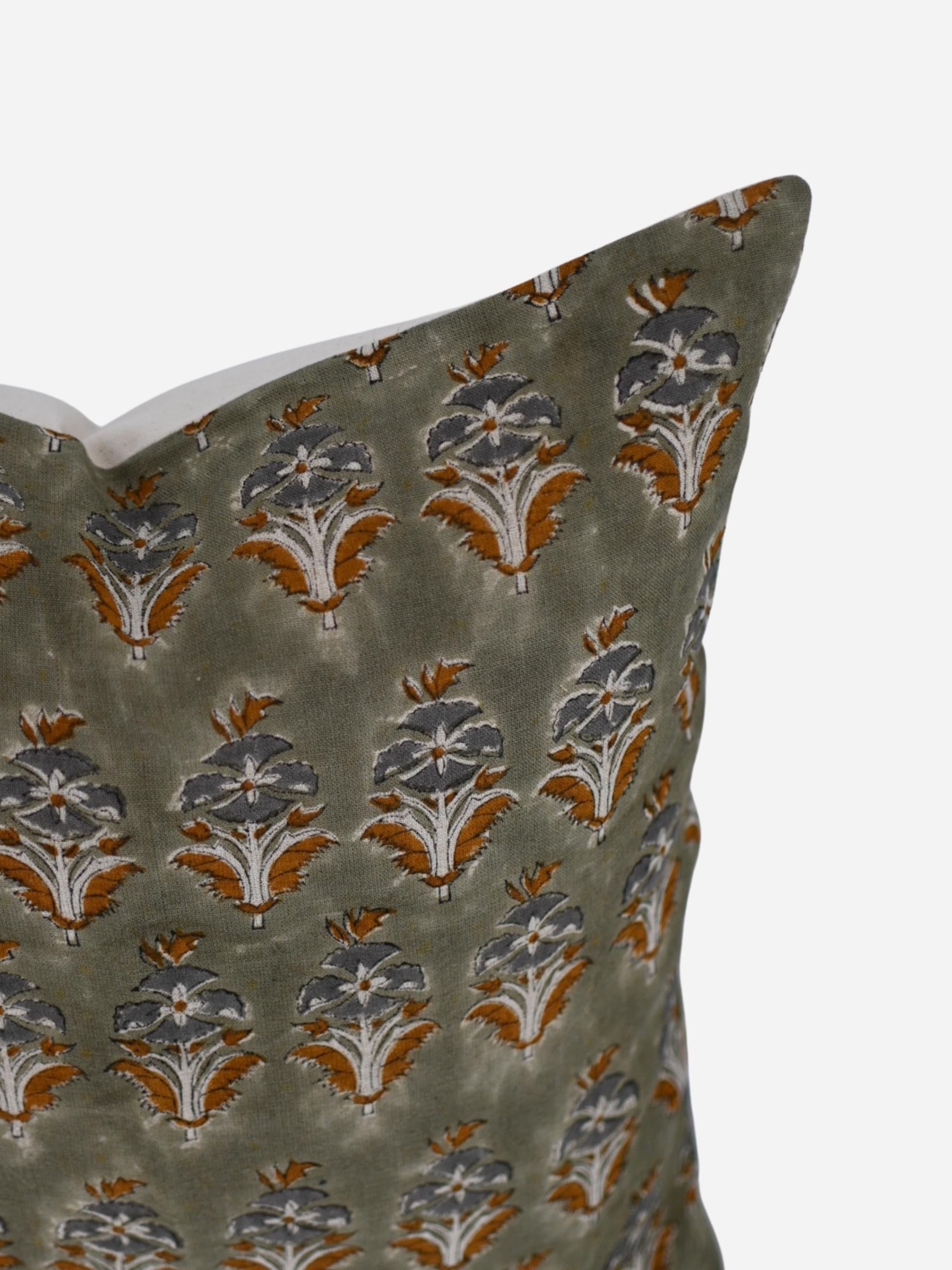 Close-up of the sage green floral buti hand block print on linen