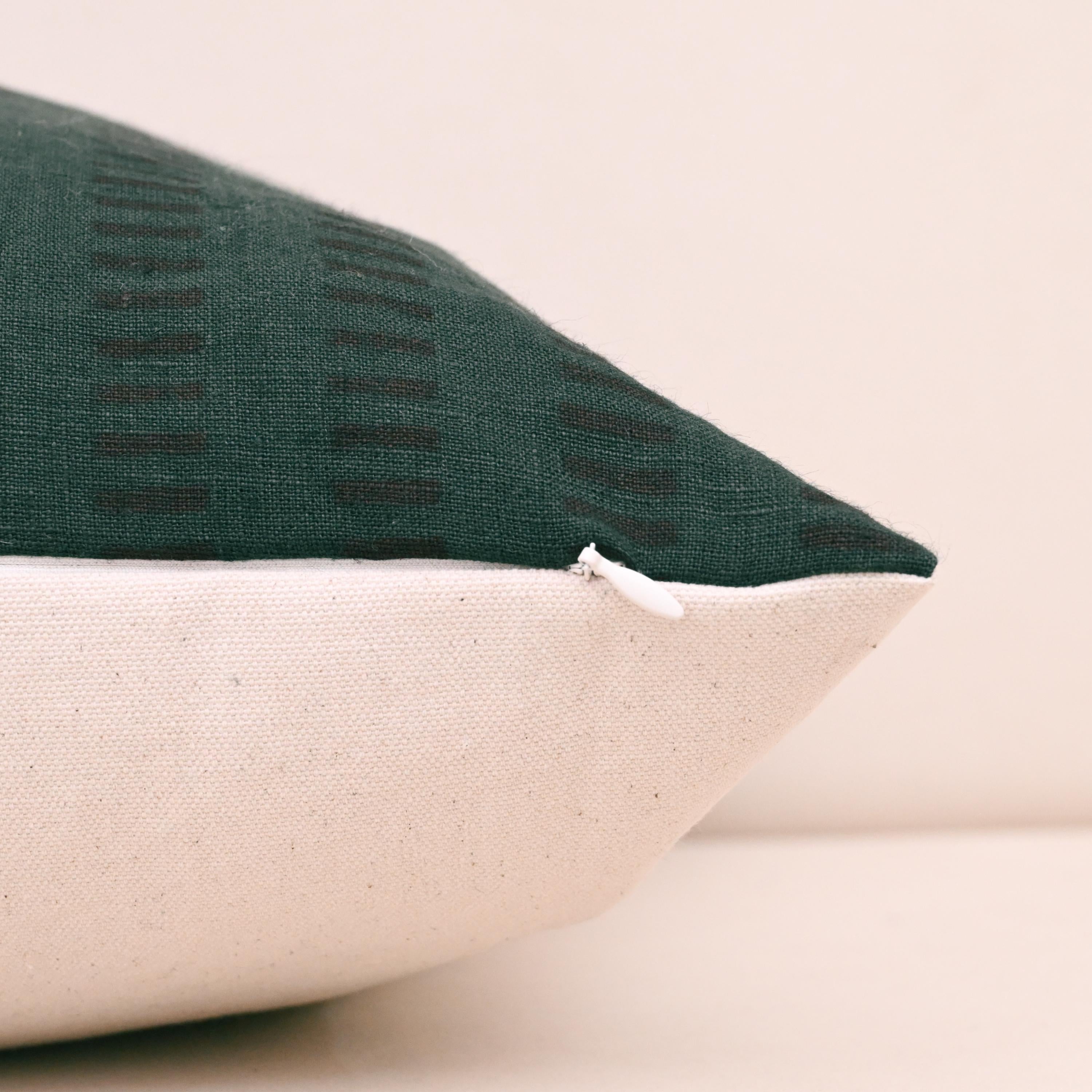 Corner detail of forest green geometric stripe linen pillow cover