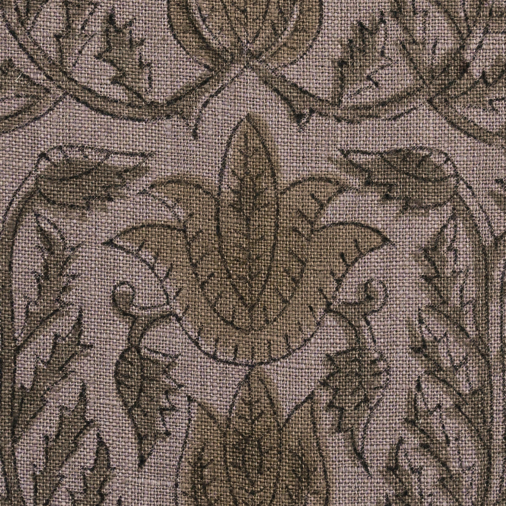 Close-up of the charcoal and khaki gold damask block print detail on mauve linen