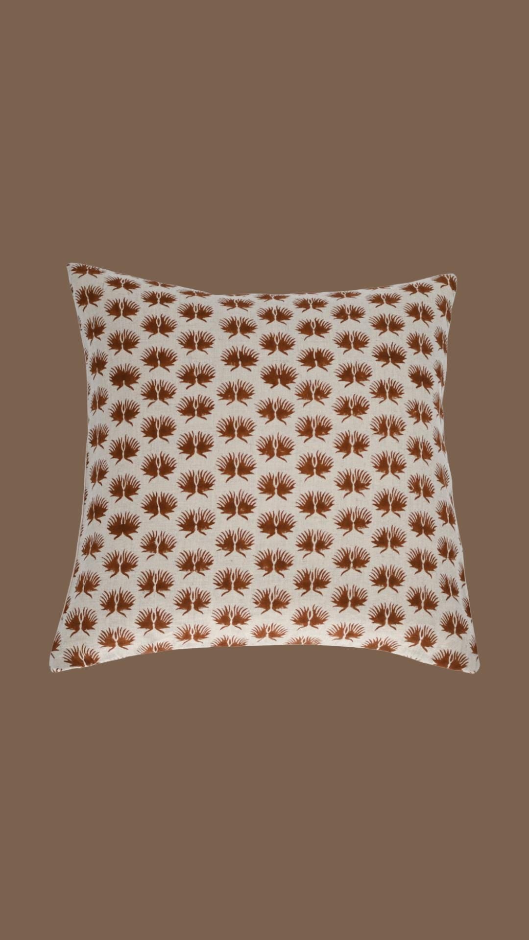 Close-up of the rust fern hand block print on natural linen