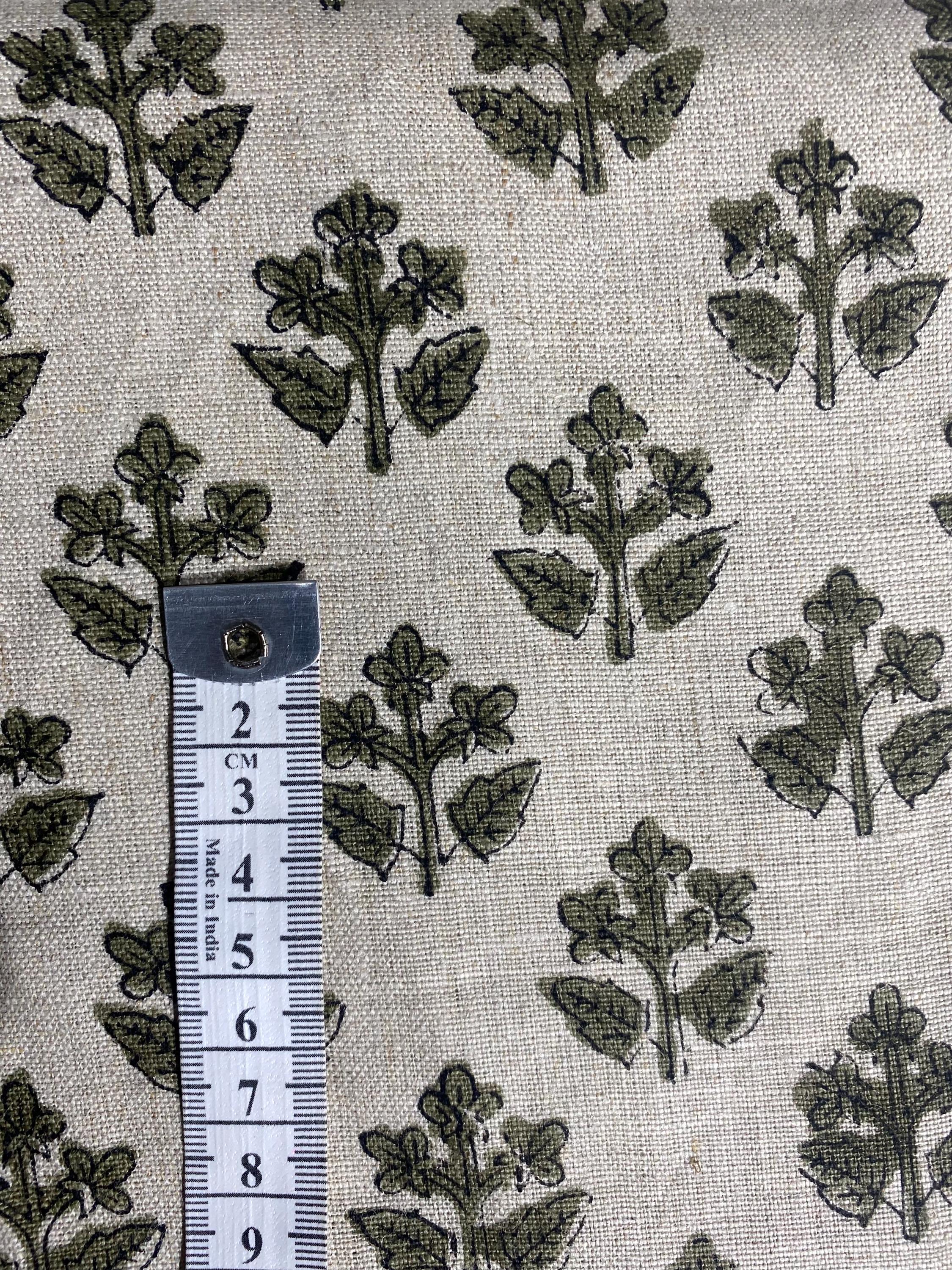 Olive green sprig hand block print linen pillow cover styled on a chair