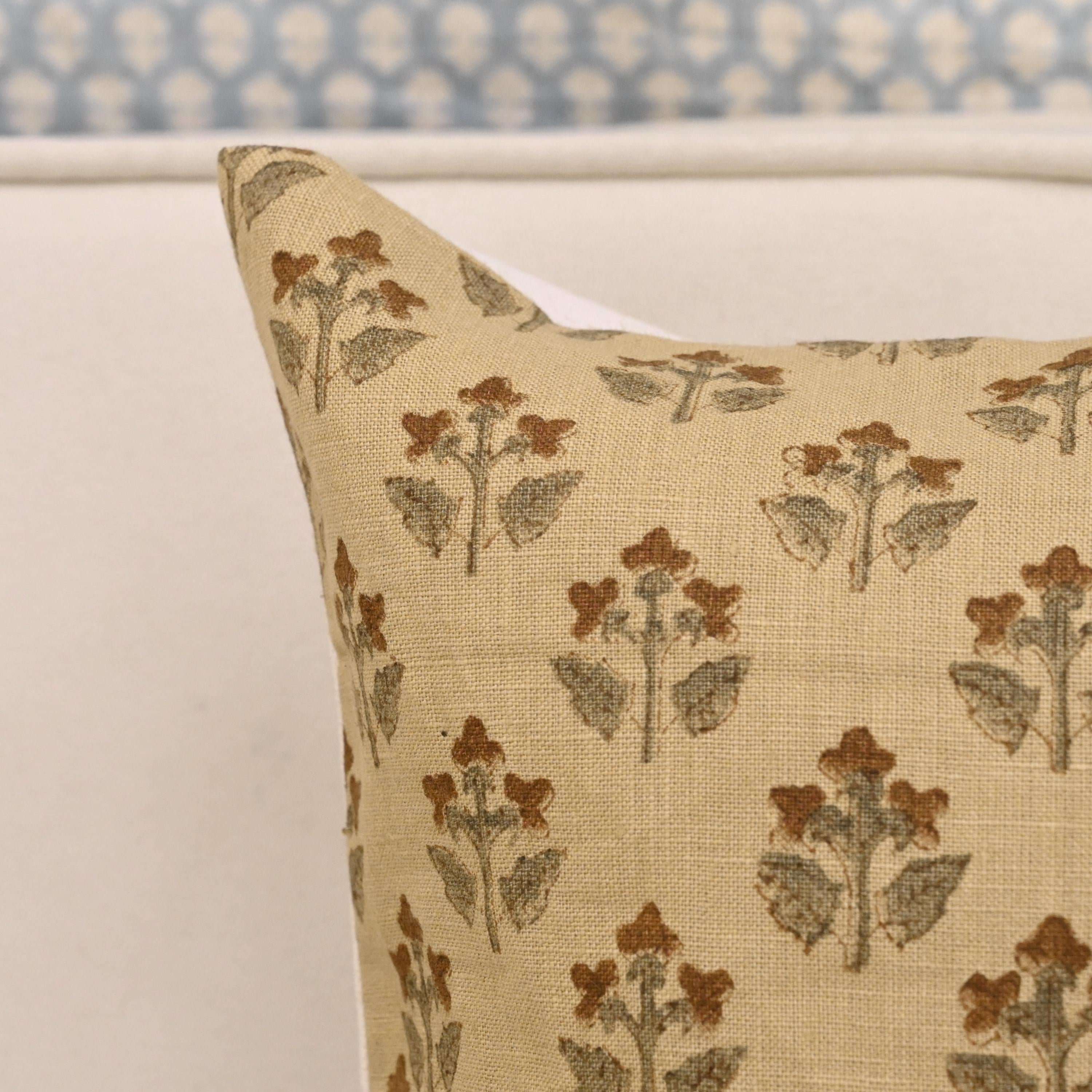 Vintage rust floral linen pillow cover styled on a sofa