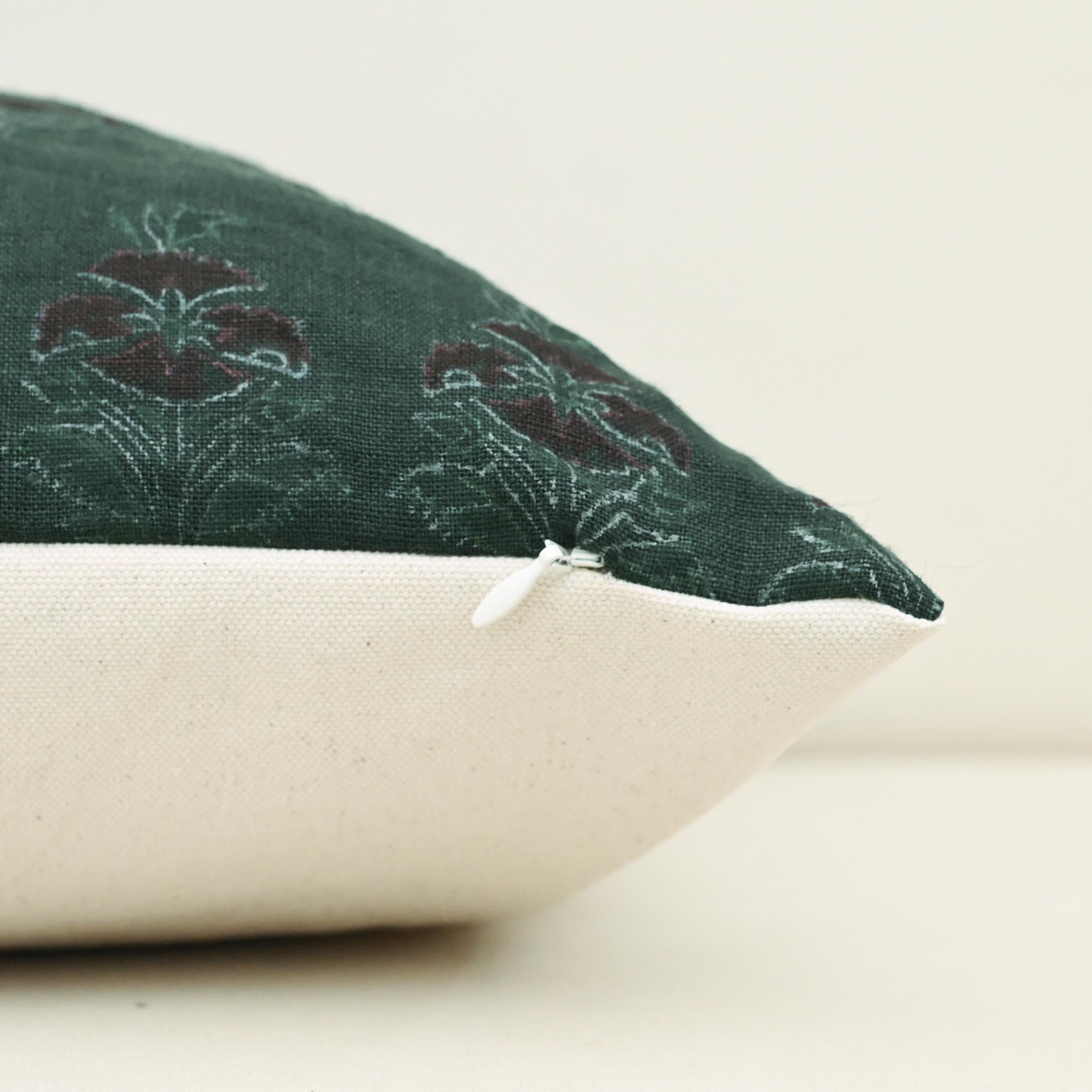 Corner detail of forest green chintz bud linen pillow cover