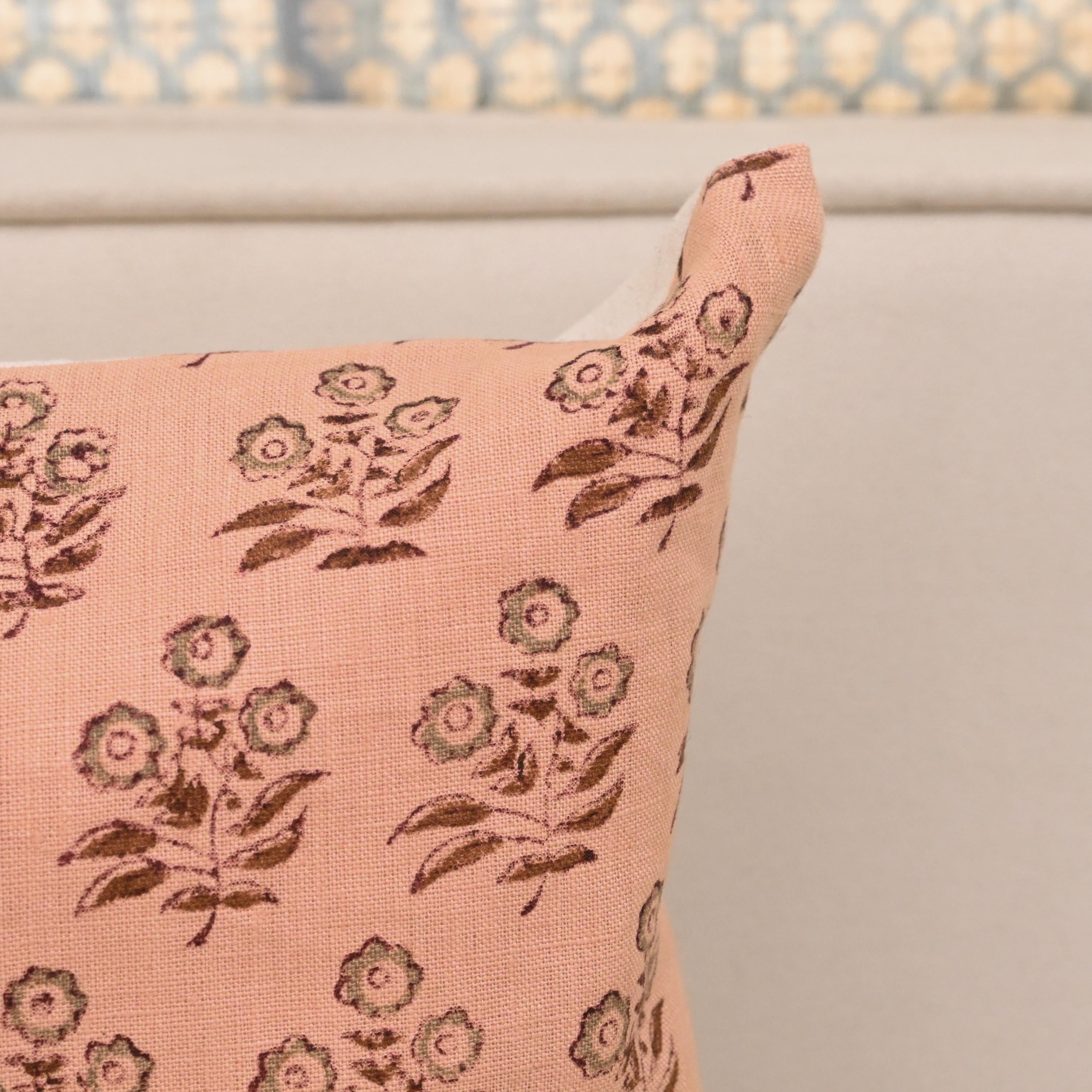 Willow peach floral linen cushion cover styled on a sofa